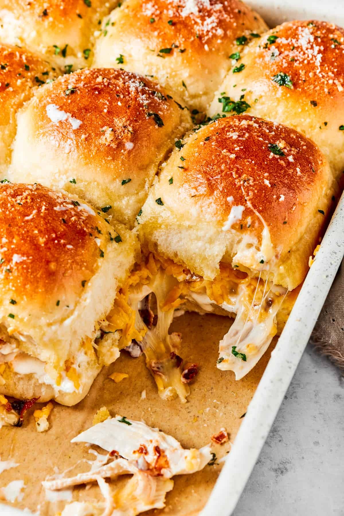 Toasted chicken bacon ranch sliders in a baking pan.
