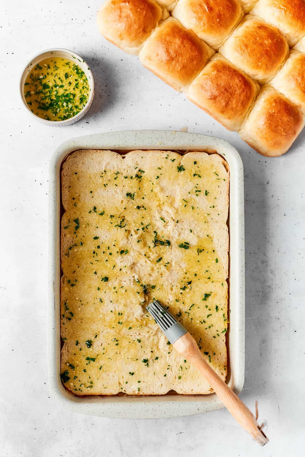 A melted butter mixture is added to a baking dish.