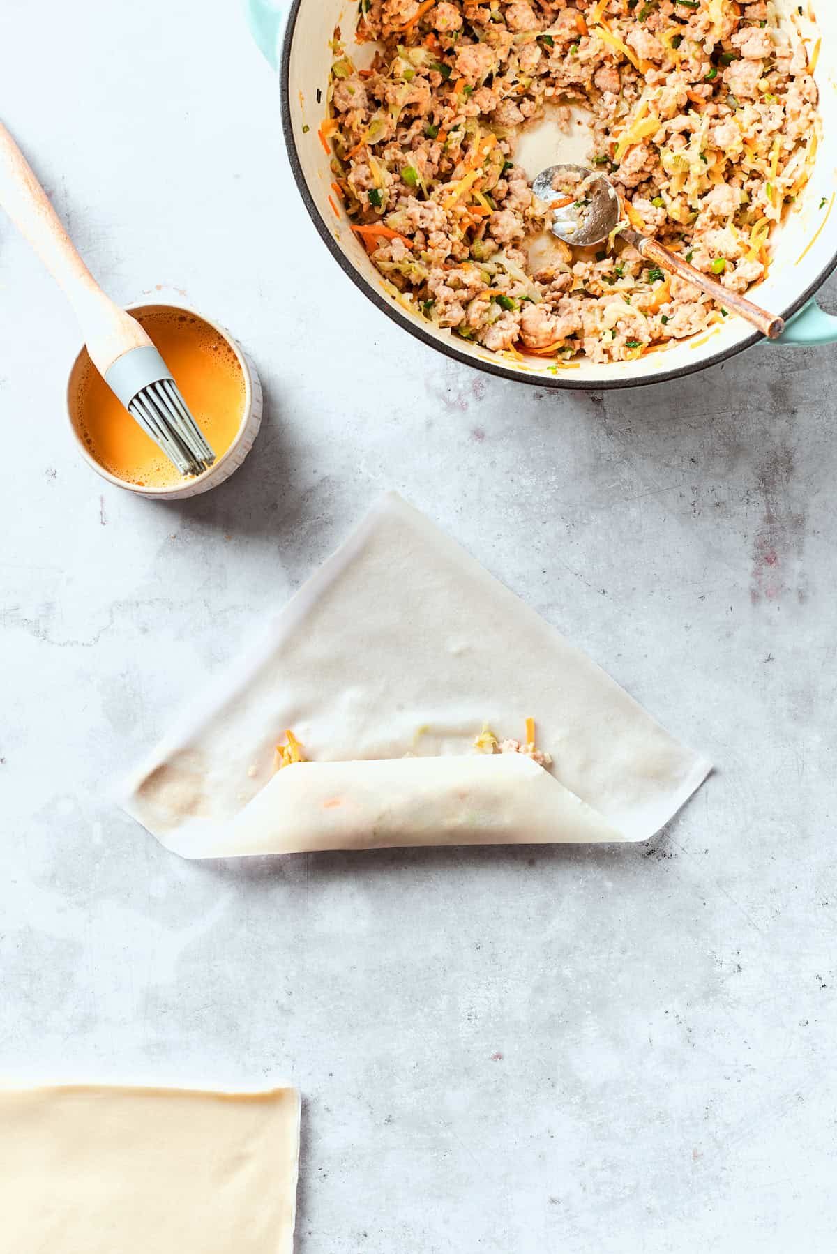 The egg roll wrapper is folded around the filling.