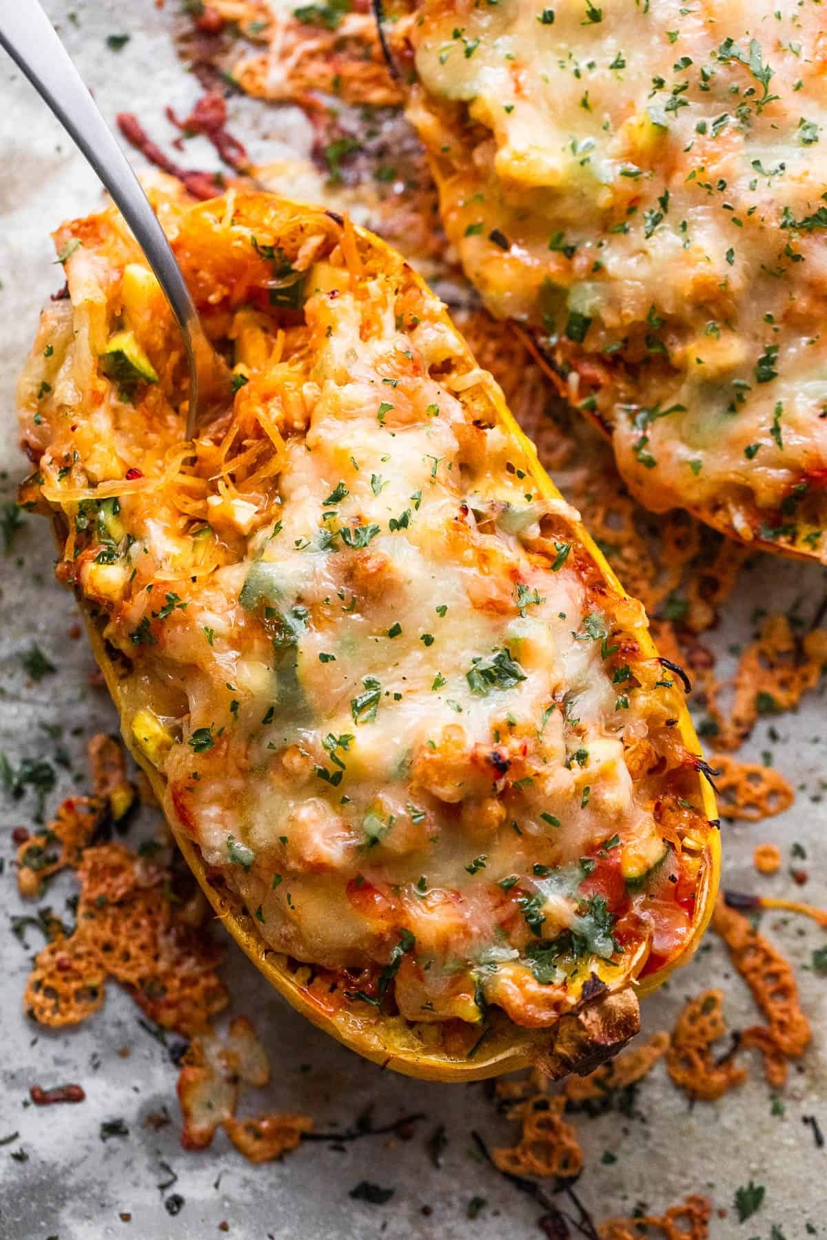 spaghetti squash stuffed with chicken enchilada filling and topped with melted cheese