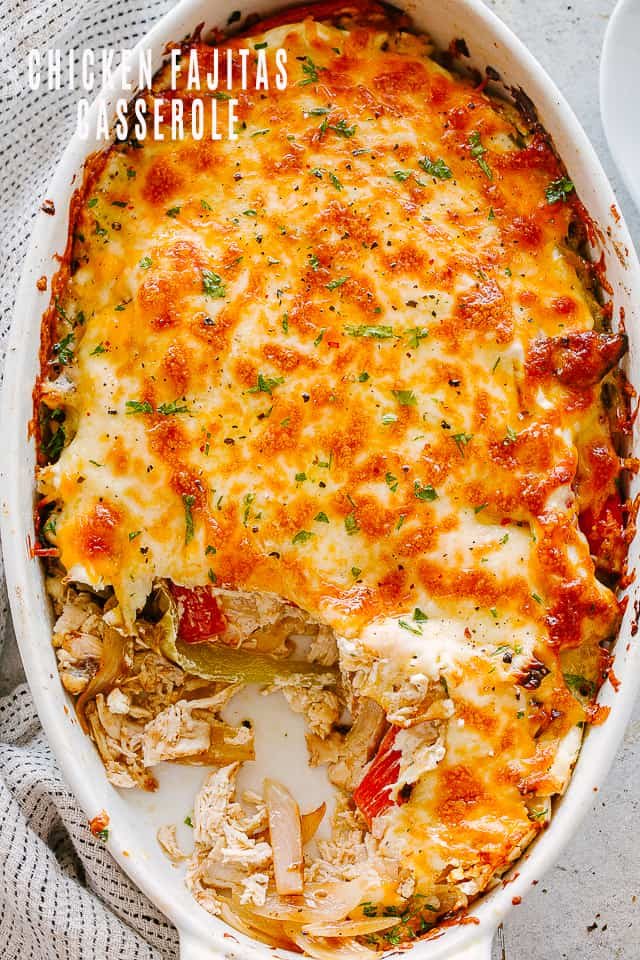 top view of chicken fajita casserole in an oval baking dish topped with melted cheese