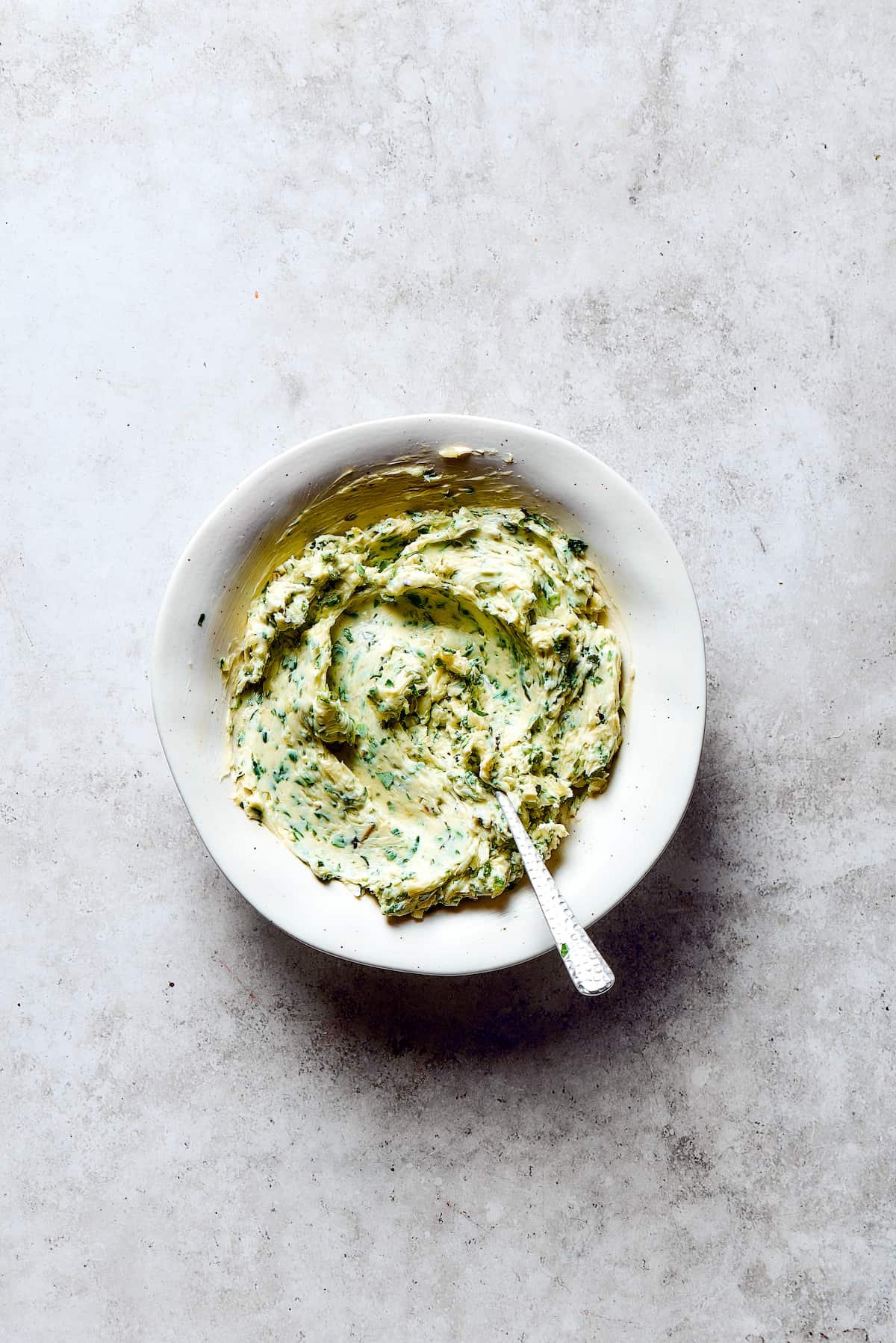 A dish of garlic herb butter.