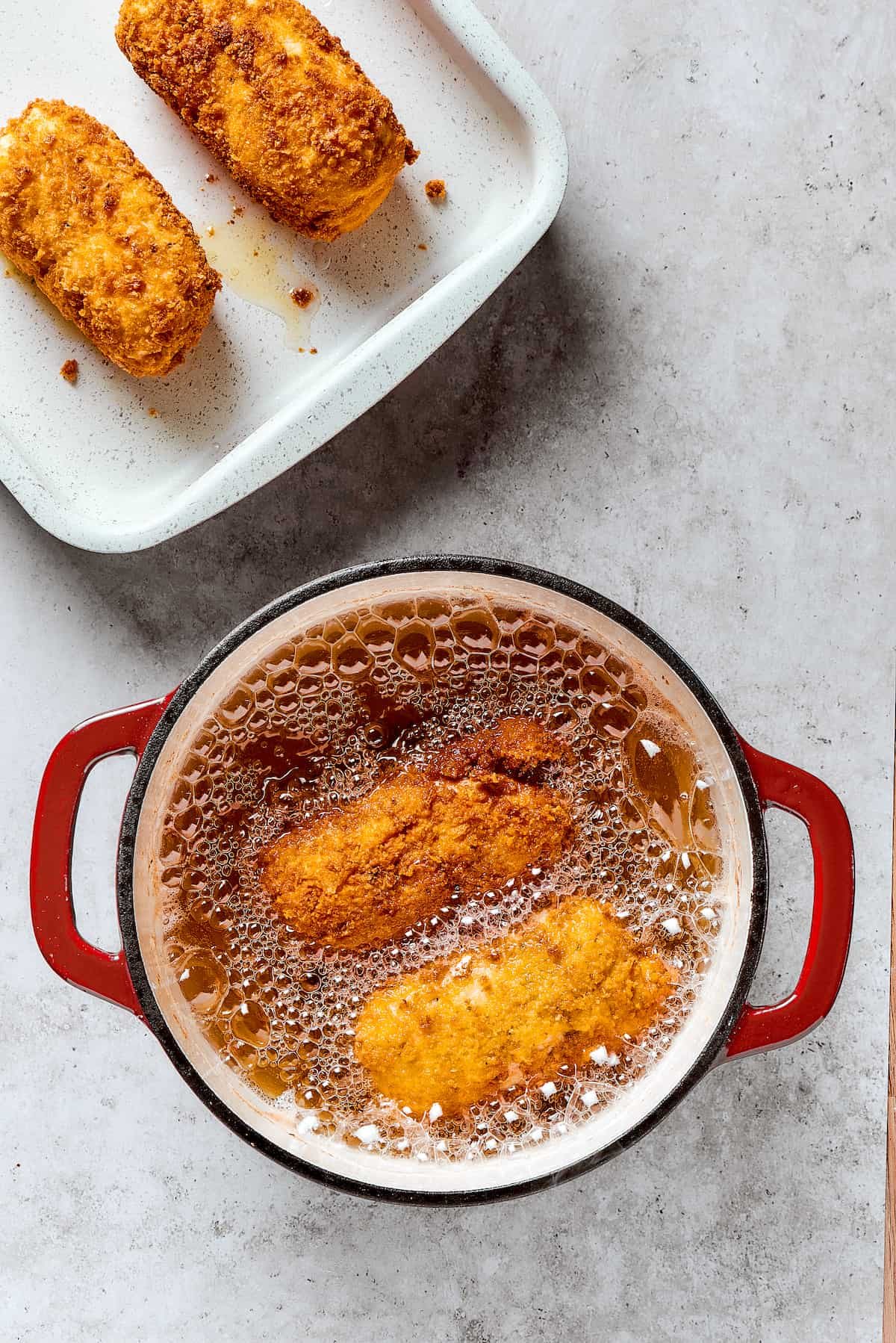 Deep-frying stuffed chicken breast in a Dutch oven.