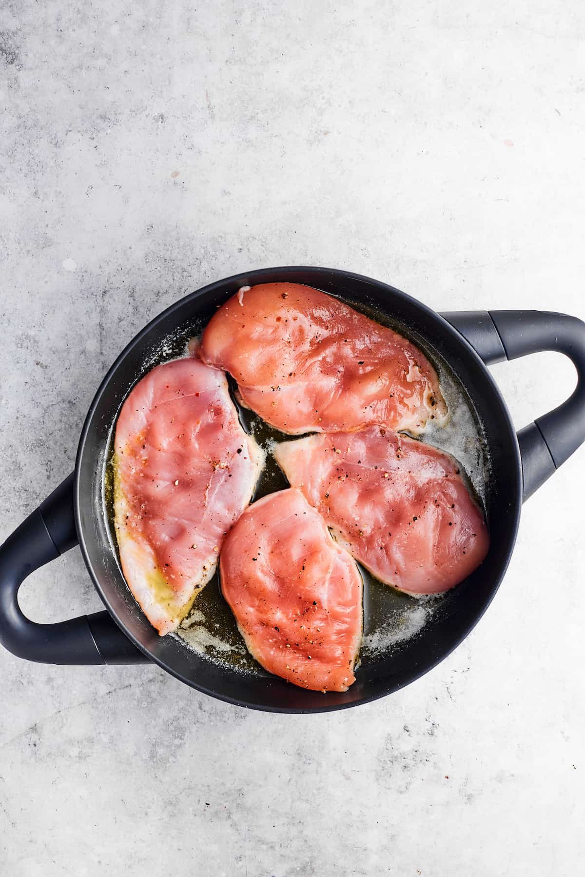 Chicken is browned in a skillet in olive oil.