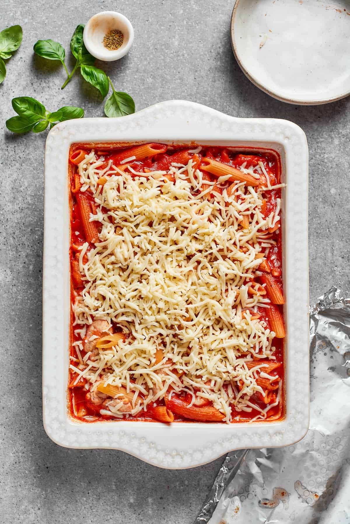 Shredded cheese is added to the casserole.