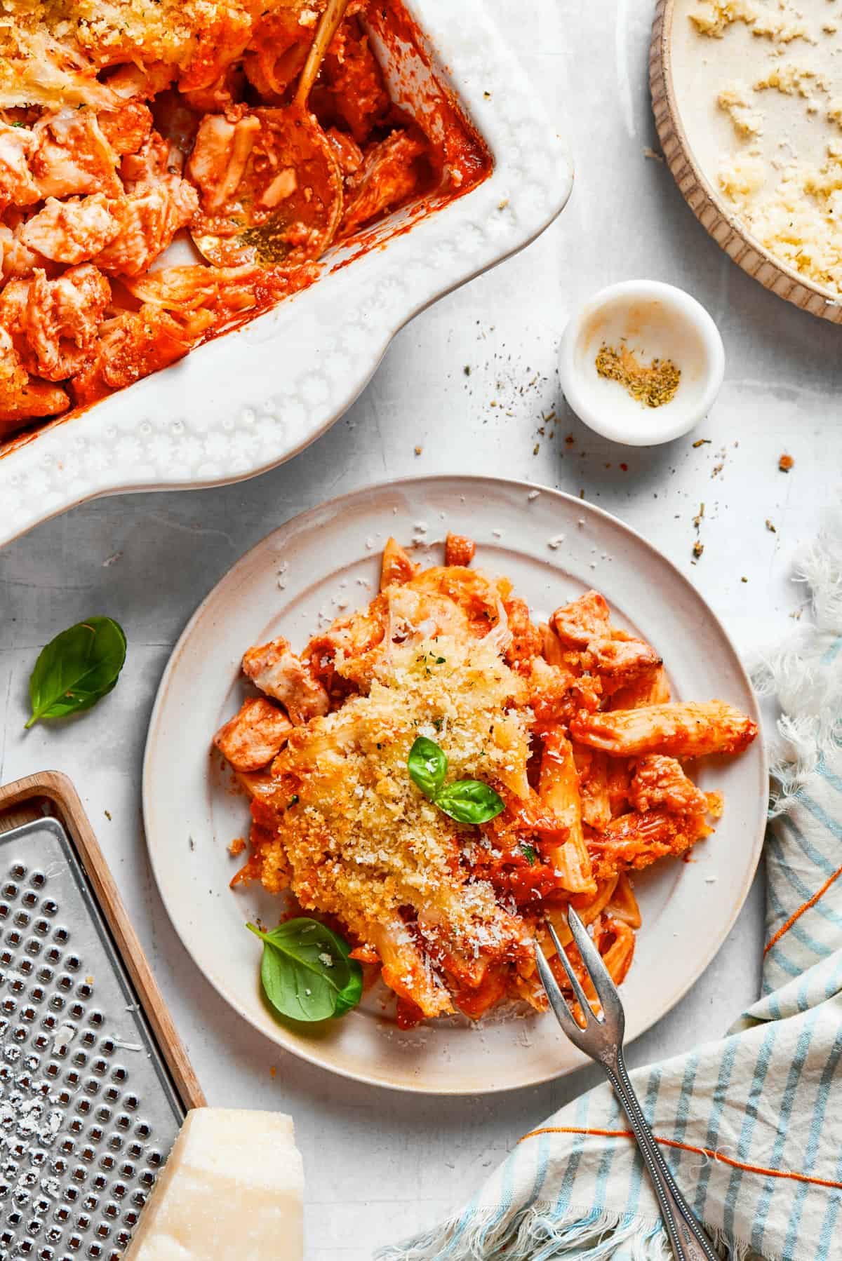 A plate of chicken parmesan casserole with a fork.