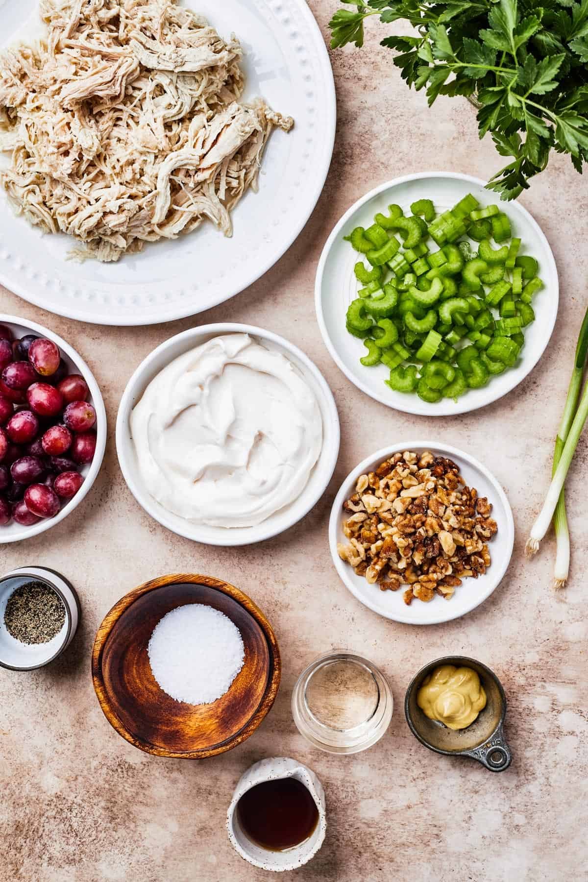 From top left: Shredded chicken, celery grapes, mayonnaise, chopped walnuts, seasonings, white wine vinegar, dijon mustard, maple syrup