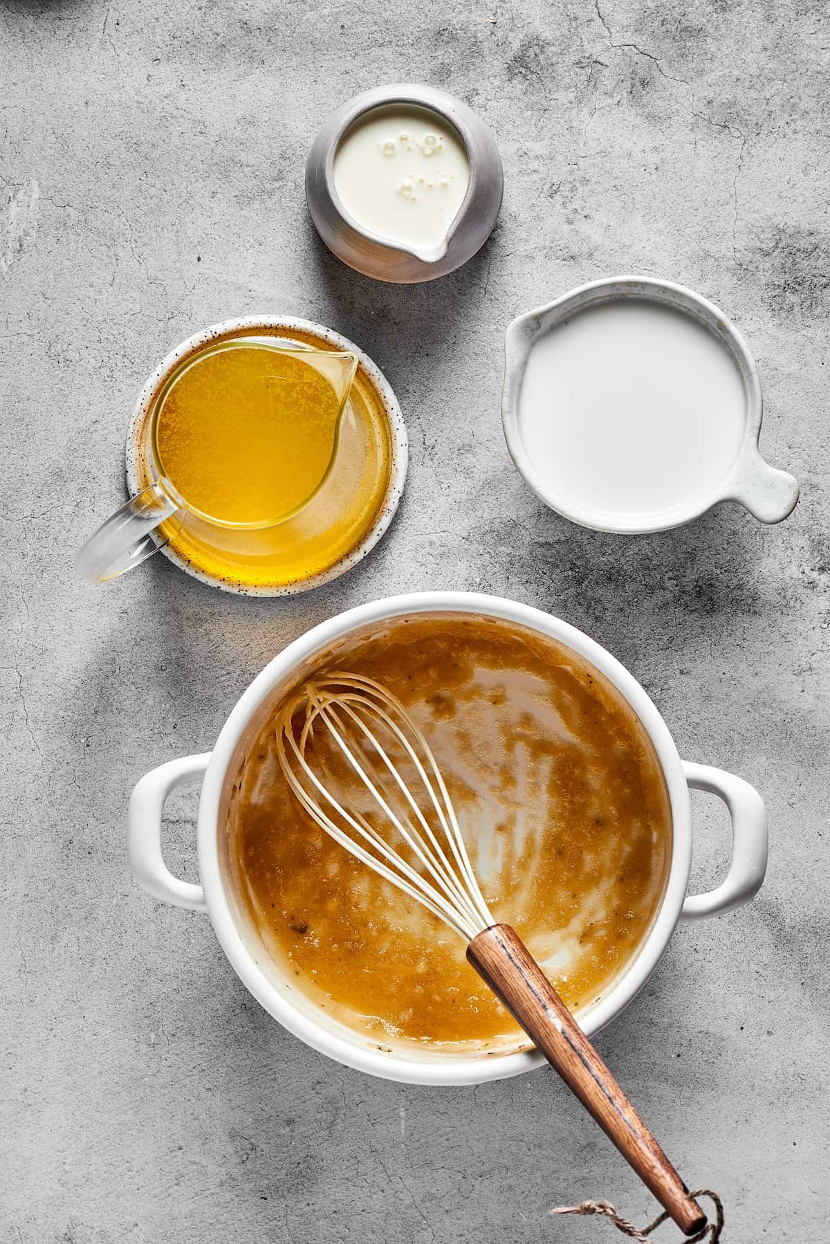 Whisking cream into the other ingredients.