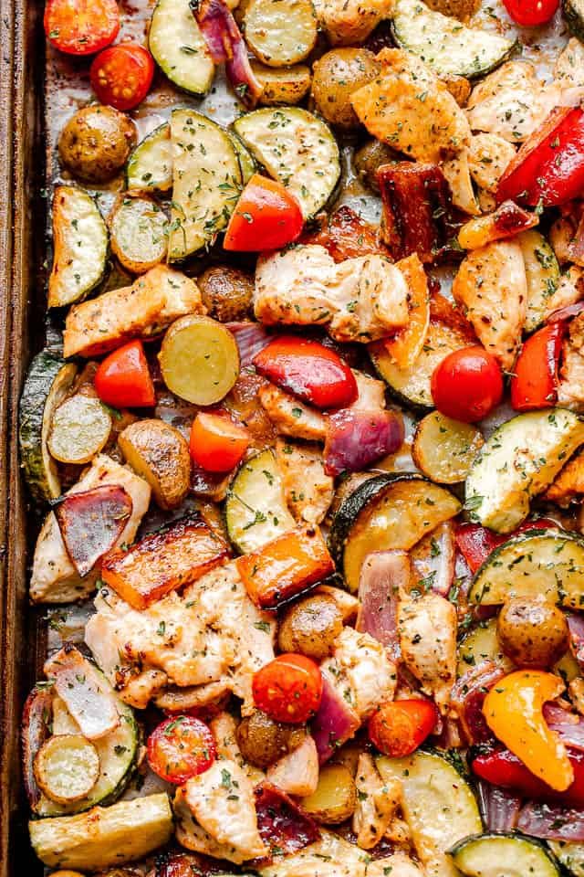 top close up shot of cooked chicken and vegetables on a sheet pan