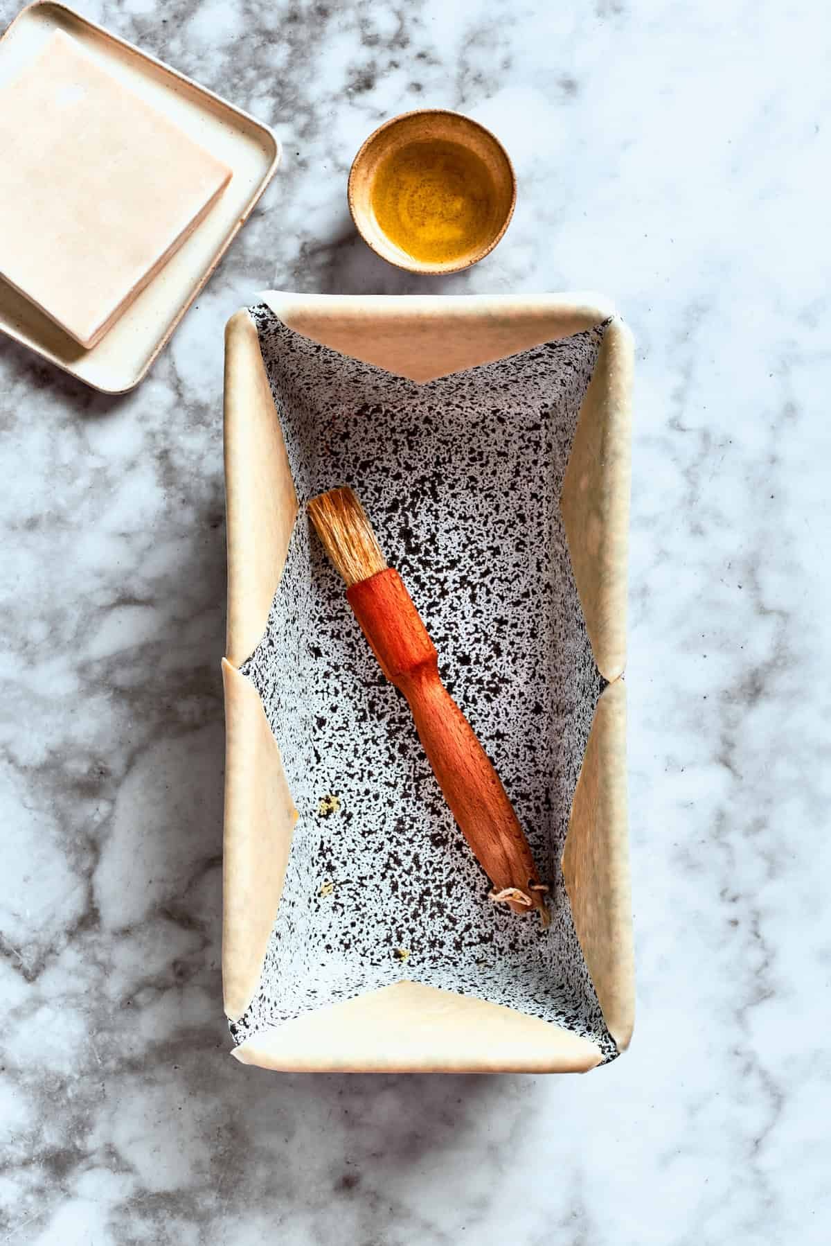 A loaf pan and a pastry brush.