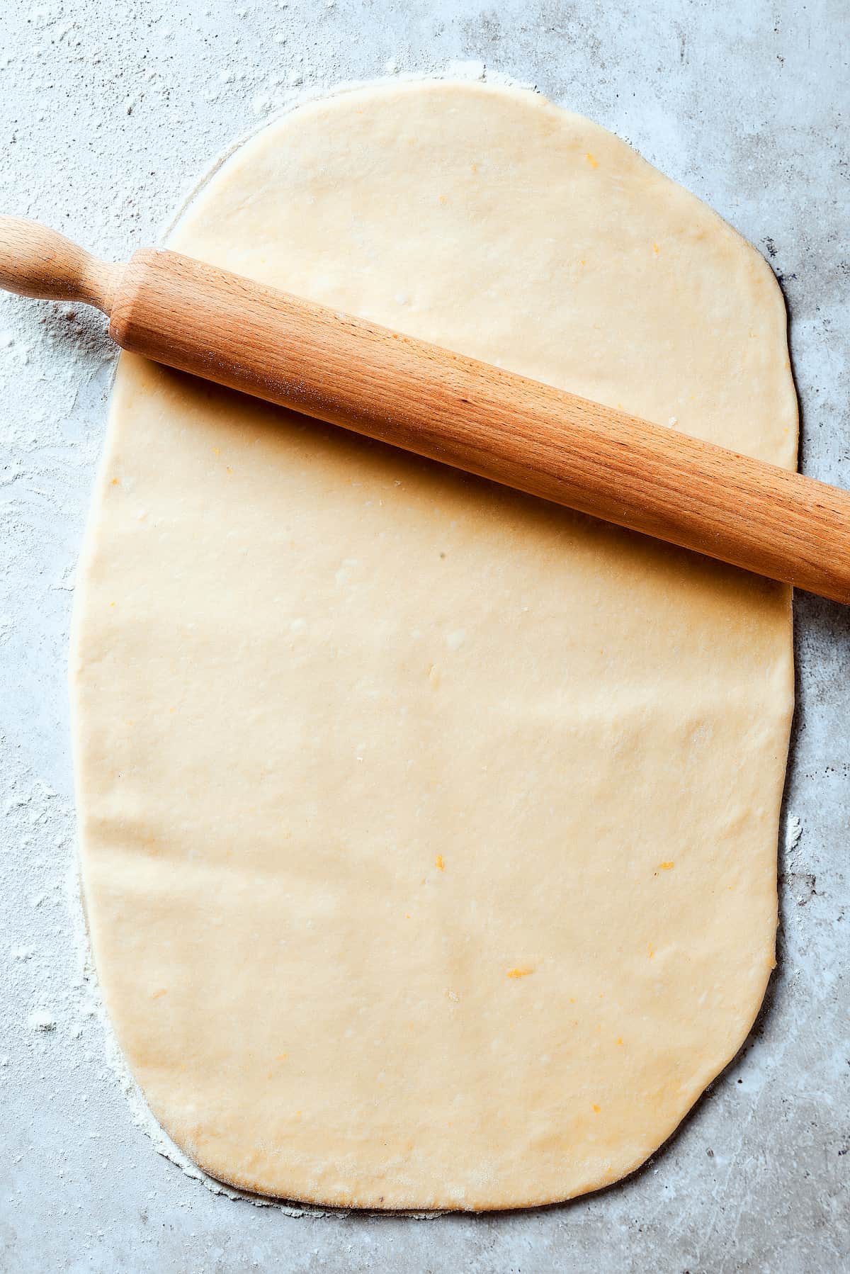 Dough rolled out into a thin rectangle.