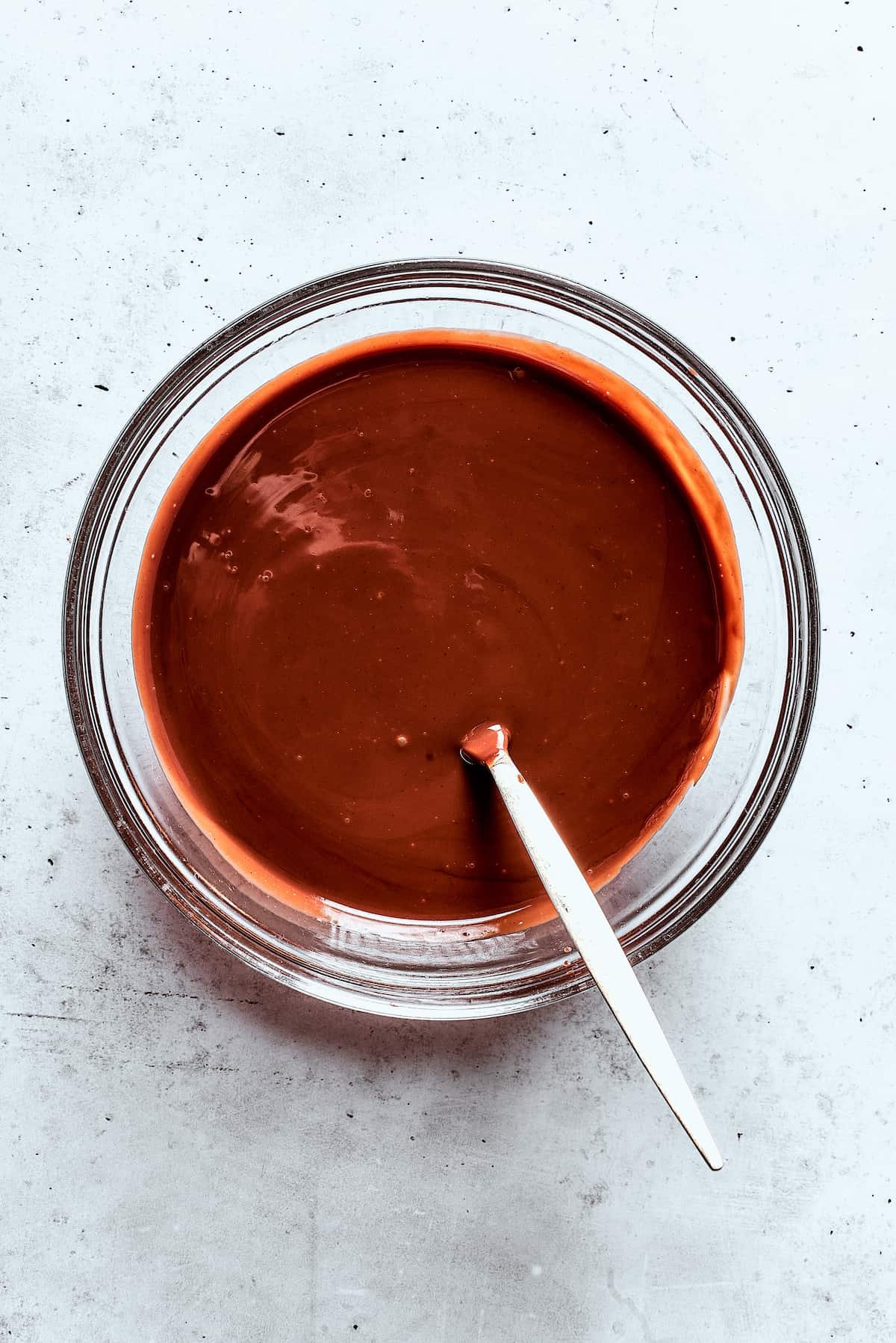 A bowl of melted chocolate sauce.