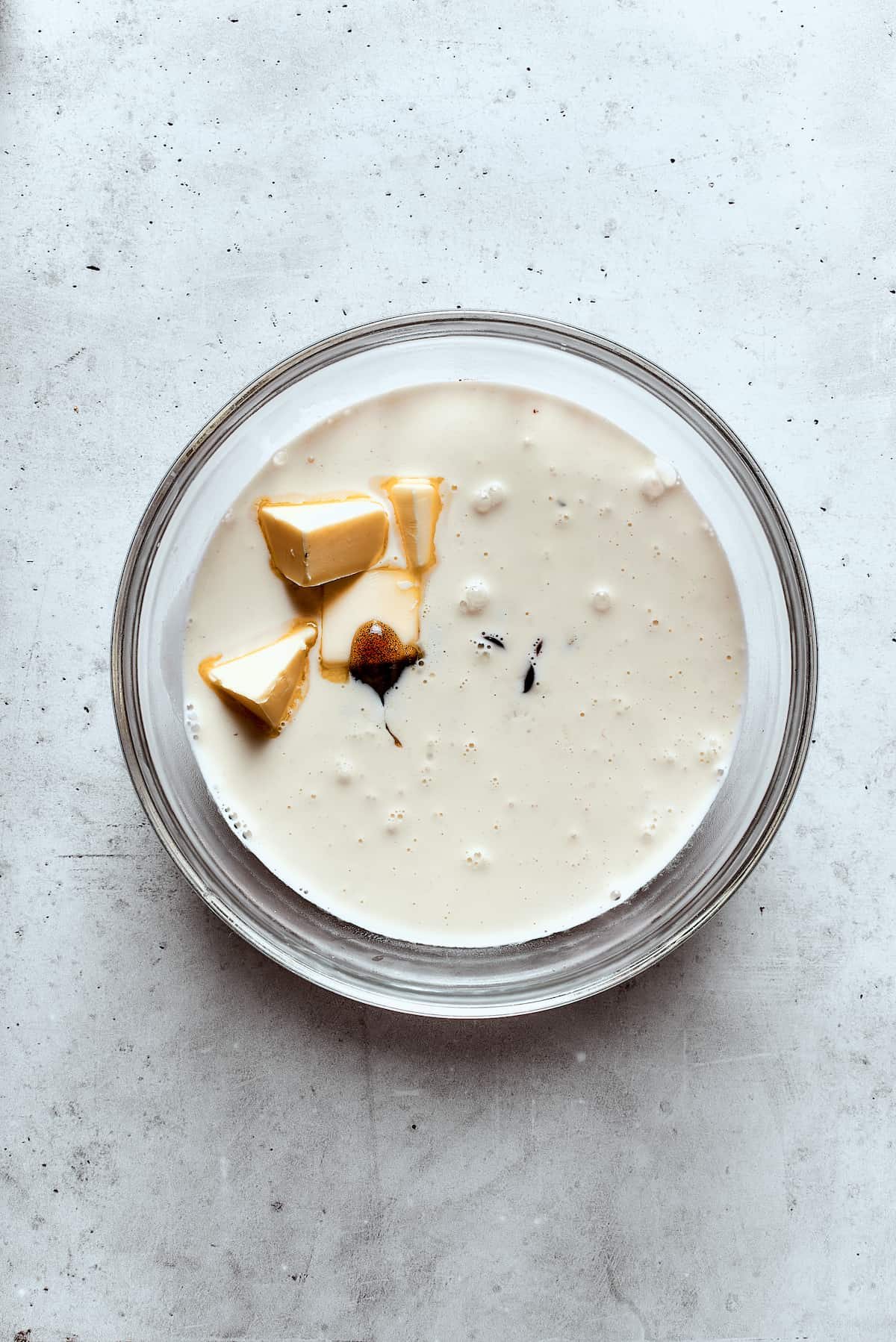 Adding butter to warm cream and chocolate.