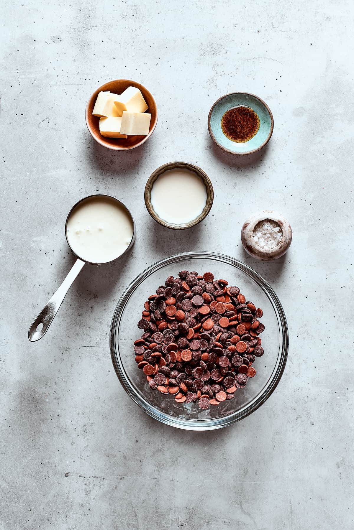 Chocolate fondue ingredients measured and arranged on a table.