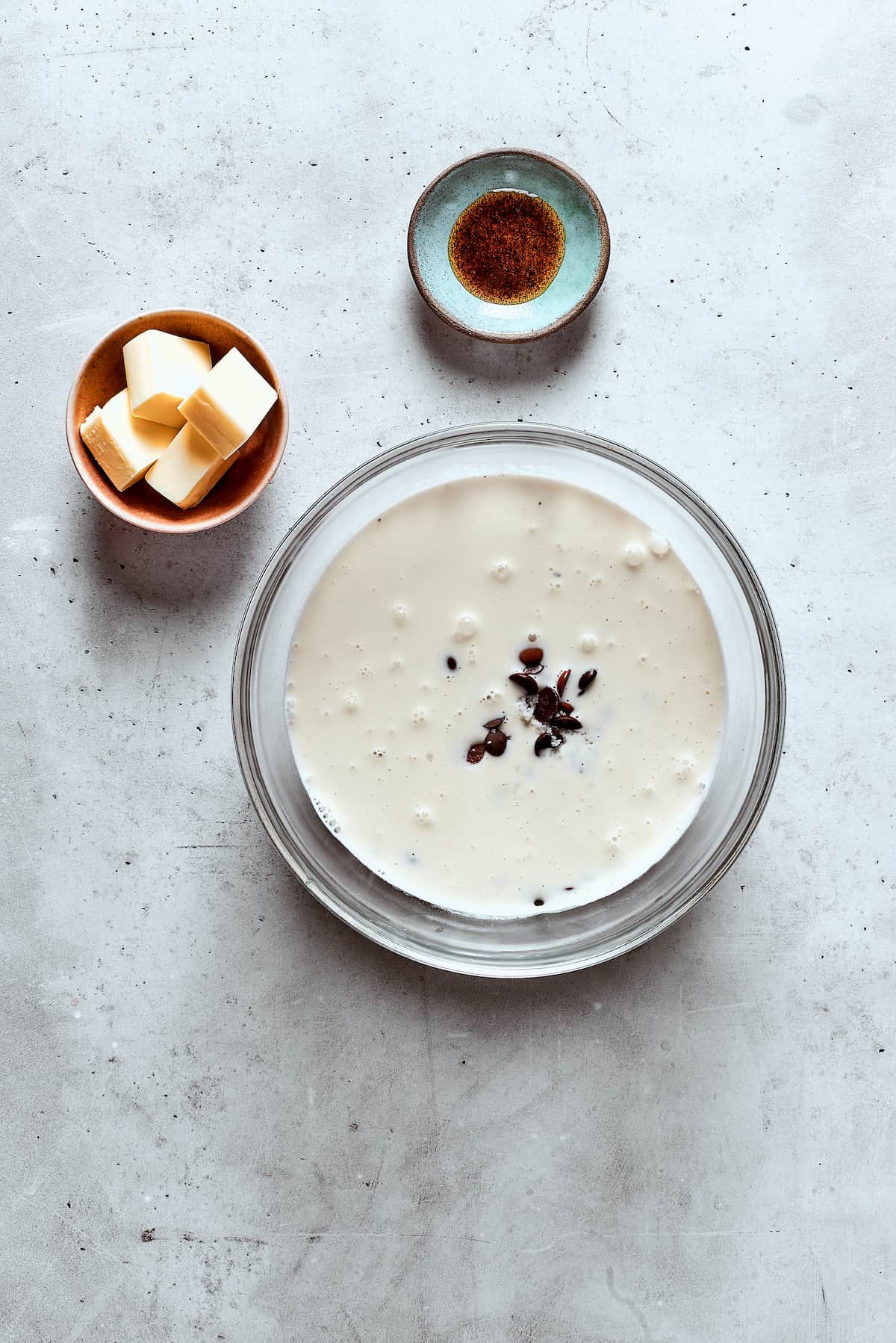 A bowl of chopped chocolate and cream.