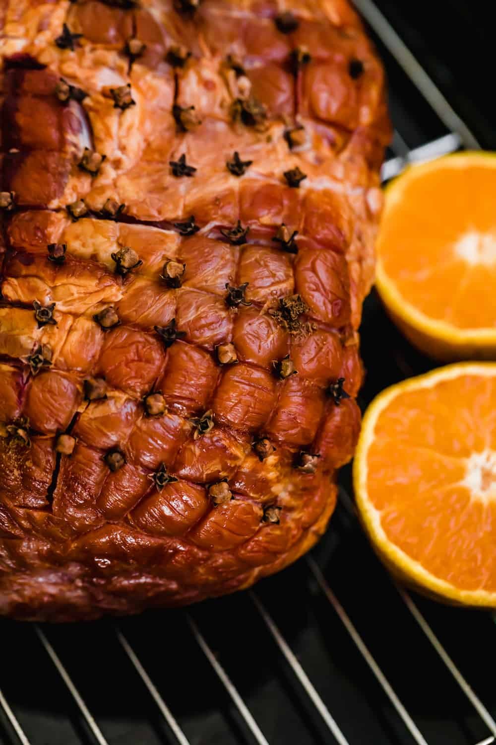 The Close-Up View of a Ham with Cloves Stuck Into It