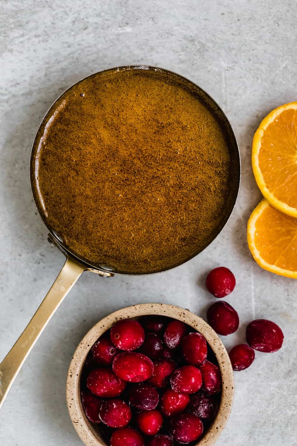 A Pan Filled with Homemade Brown Sugar Glaze Beside a Bowl of Fruit