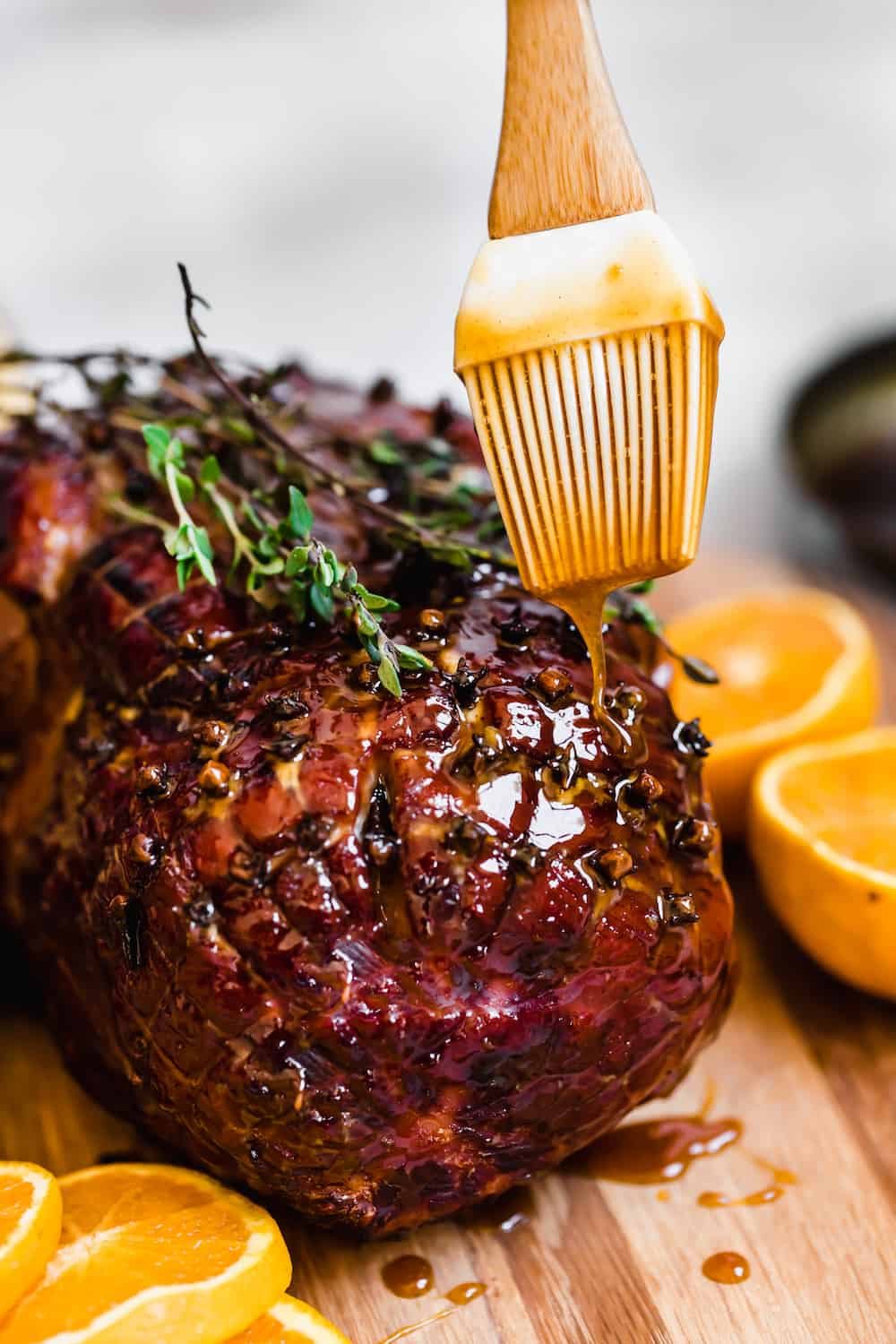 Brown Sugar Glaze Being Poured Over a Fresh-From-the-Oven Ham