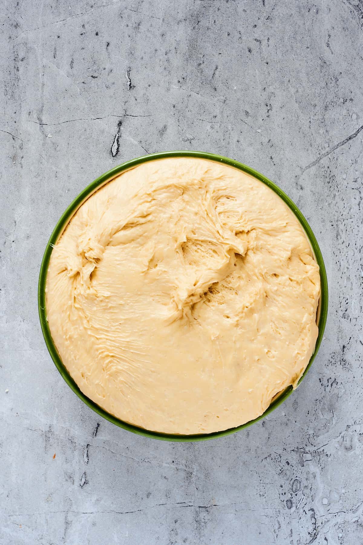 Yeast dough that has risen to the top of its bowl.