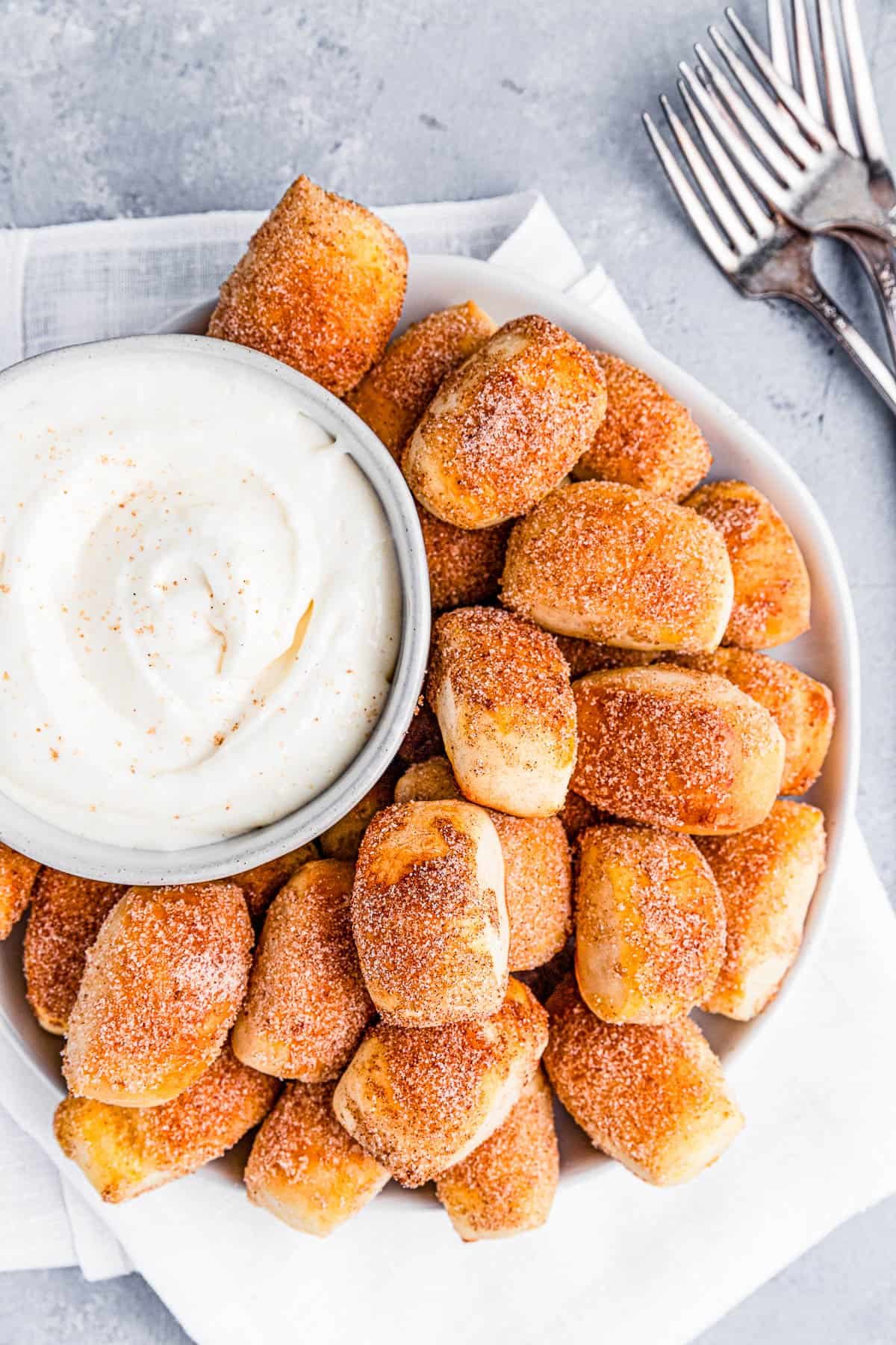 A plate of cinnamon sugar pretzel bites with dip