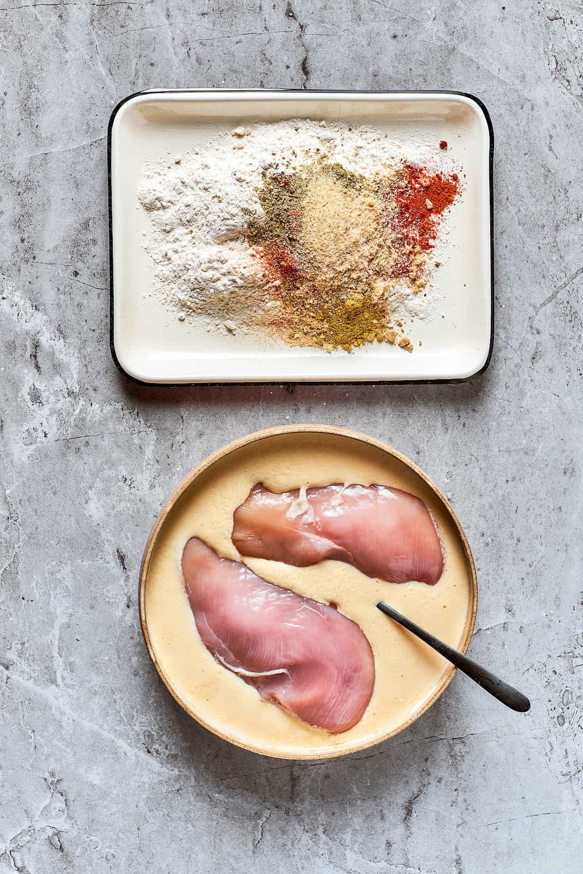 Soaking the chicken in a mixture of eggs and buttermilk.