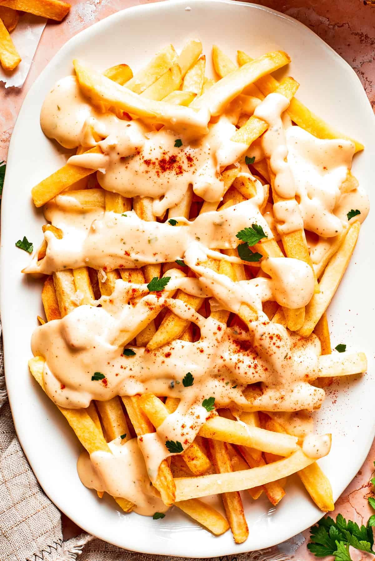 A platter of voodoo fries topped with cheese sauce.