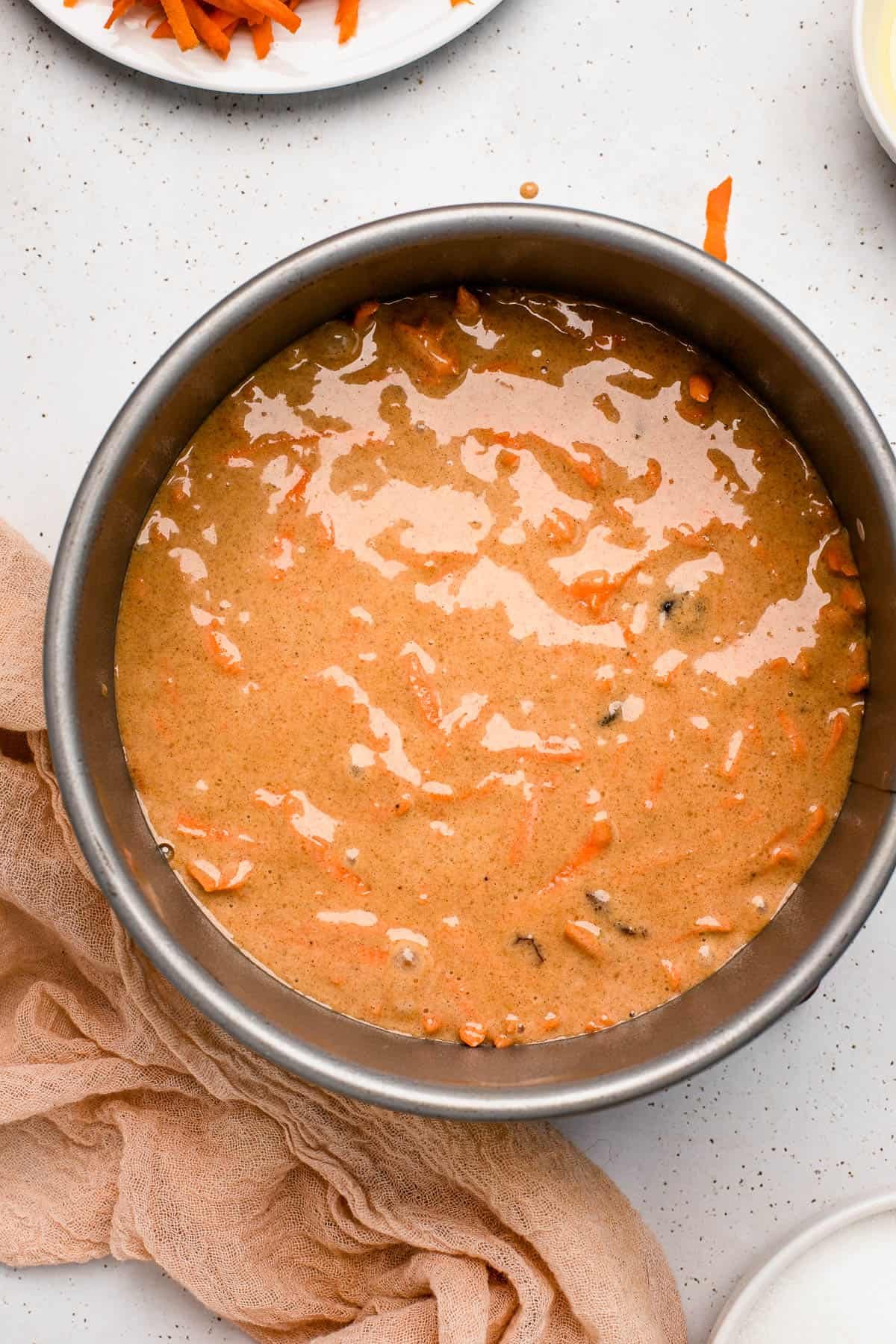 overhead shot of carrot cake batter in a springform pan