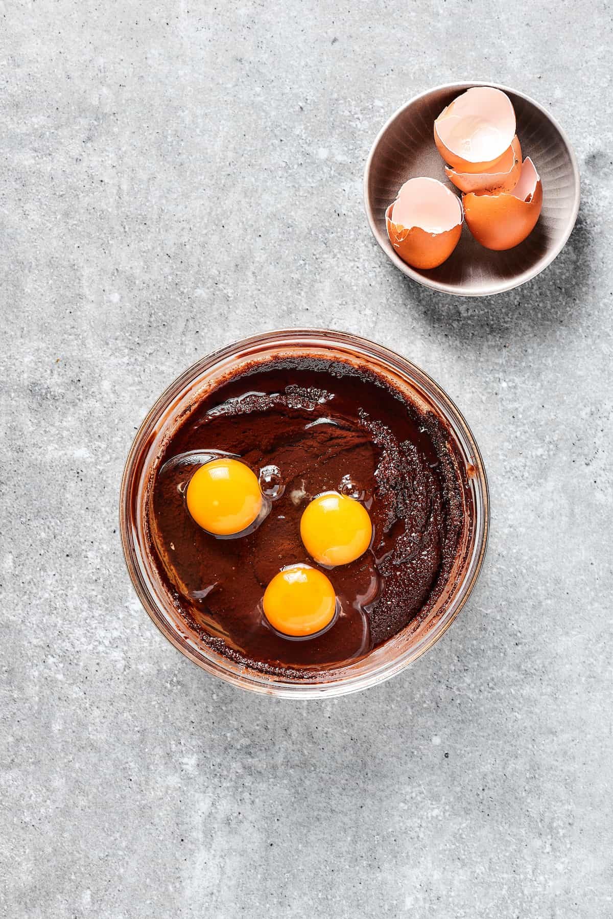 Adding eggs to brownie batter.