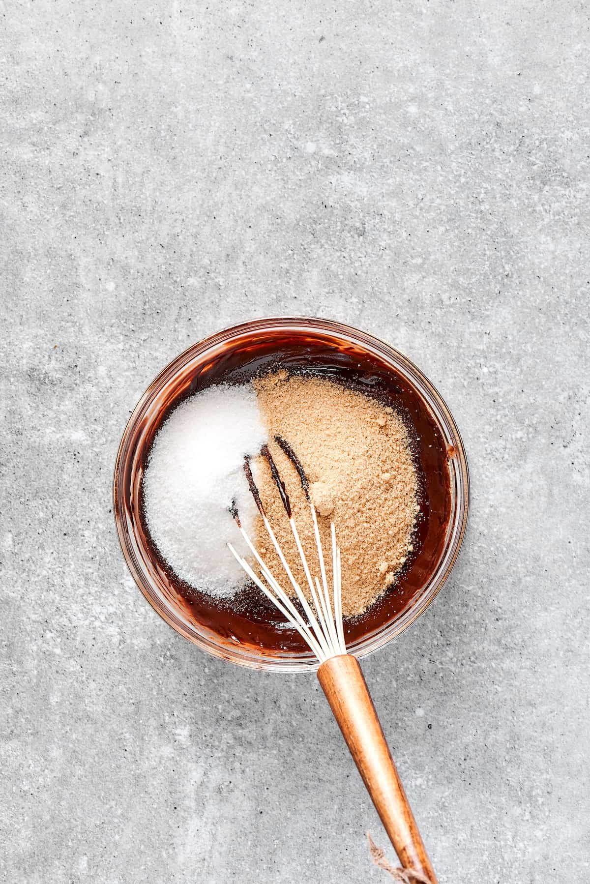 Whisking sugar into brownie batter.