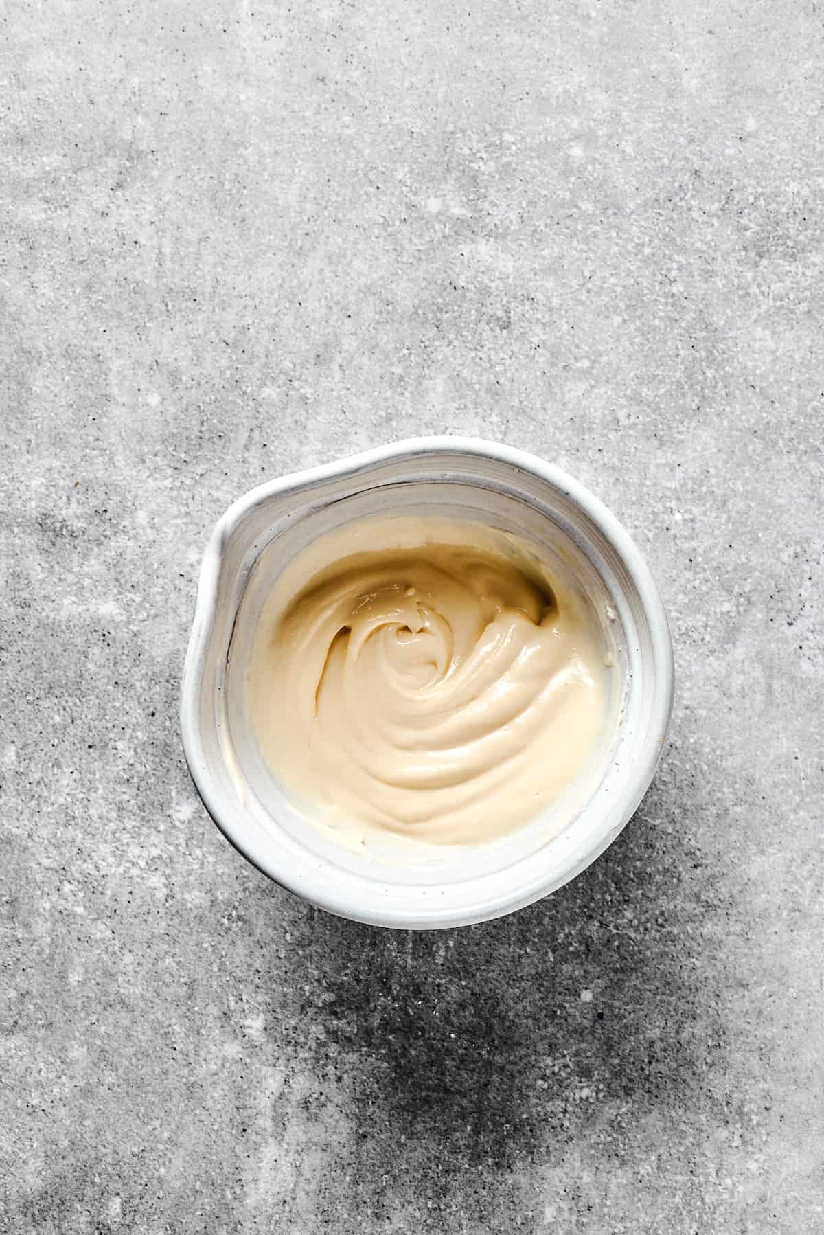 Cream cheese swirl mixture in a white mixing bowl.