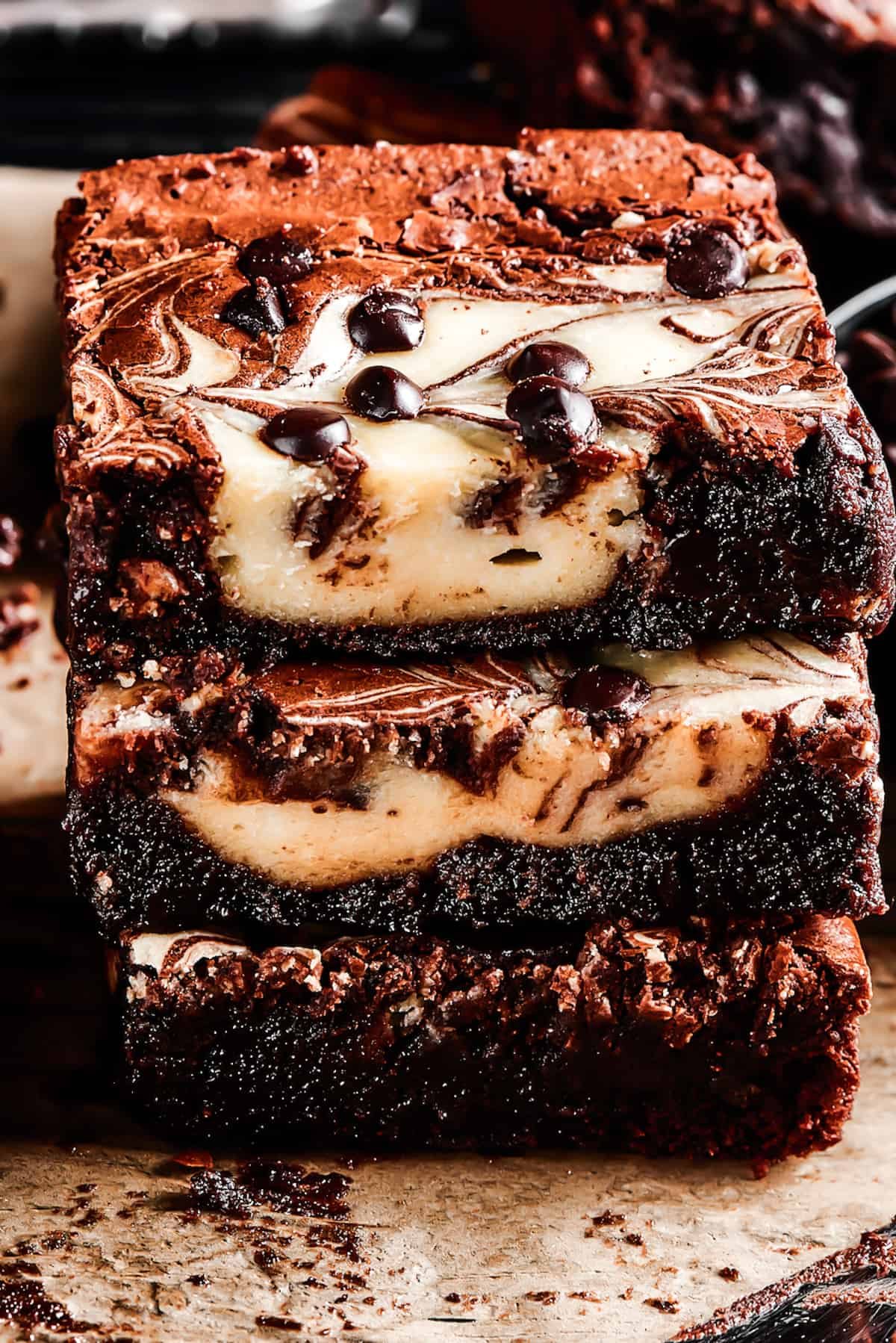 three cream cheese Brownies stacked on a wire rack.