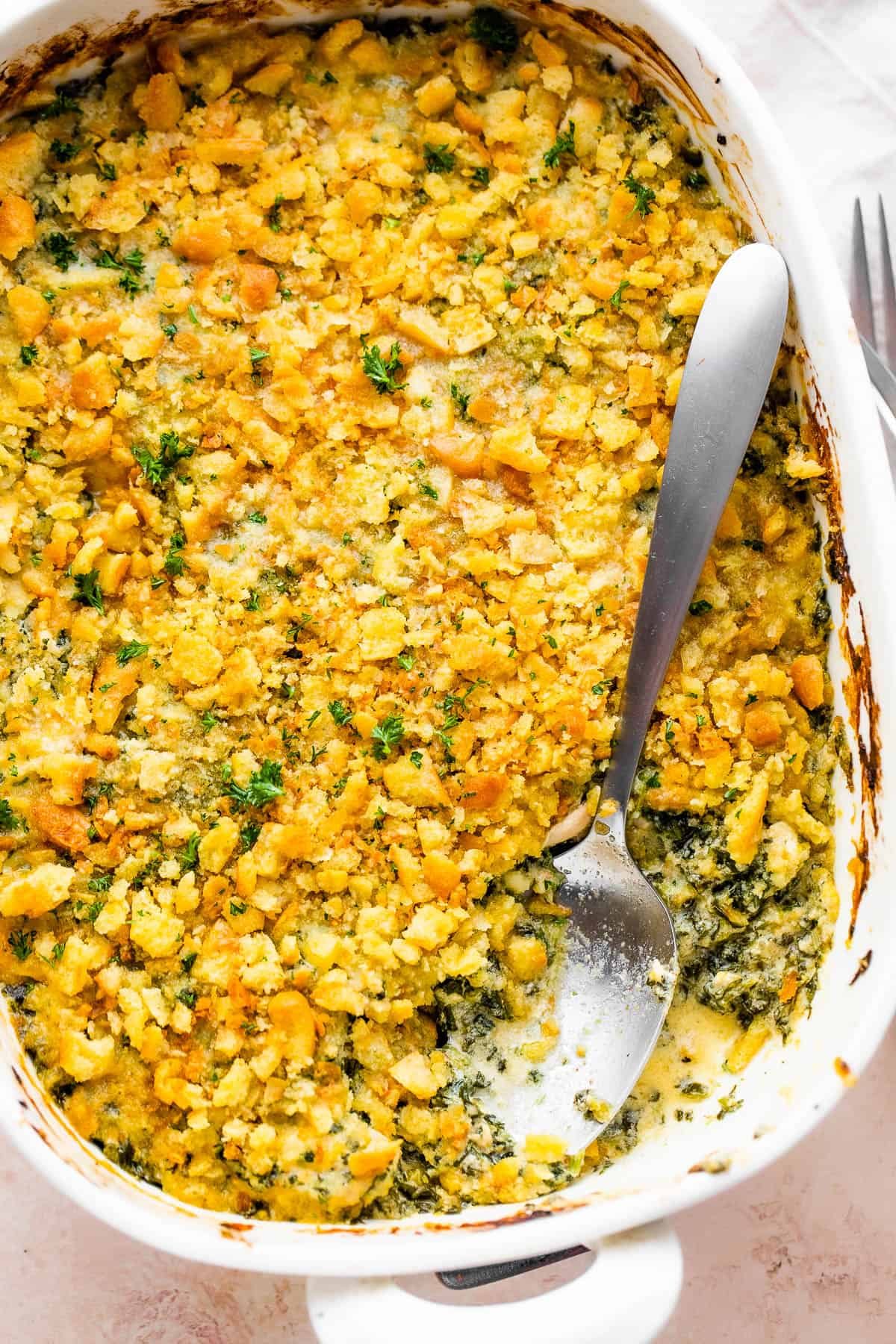 overhead shot of chicken casserole with a large spoon in it