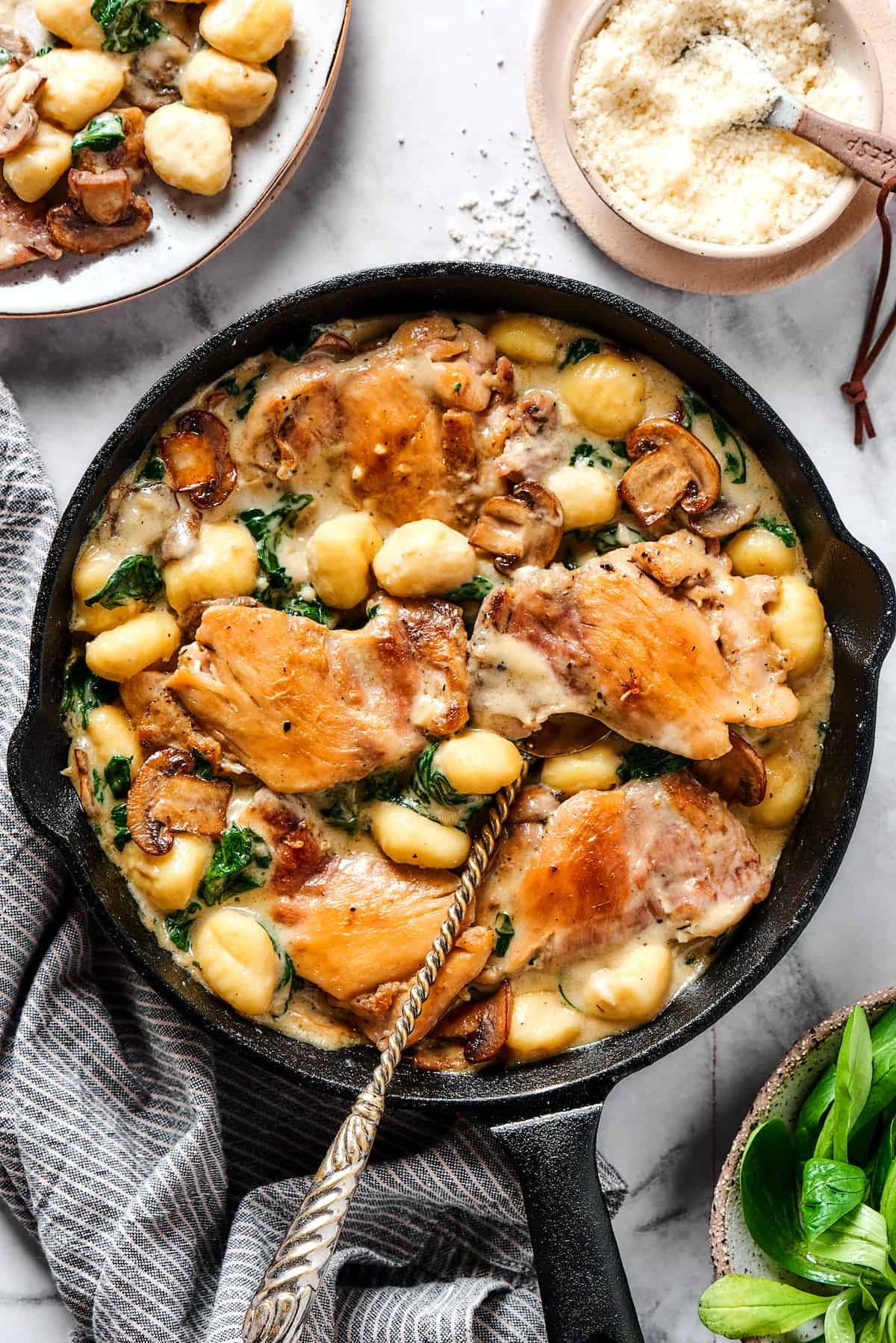 Creamy chicken and gnocchi in a cast-iron skillet.