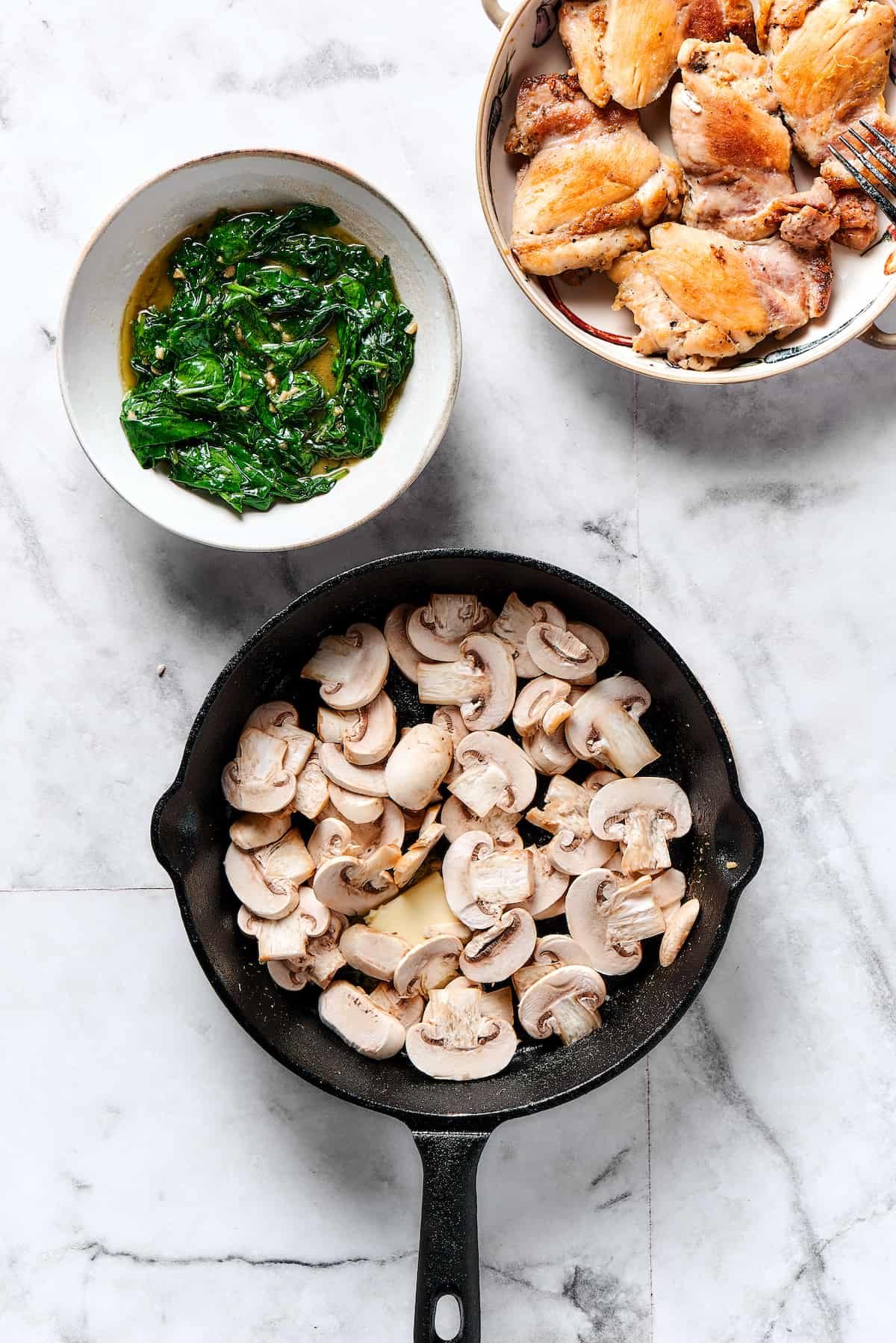 Sliced mushrooms cooking in a skillet.