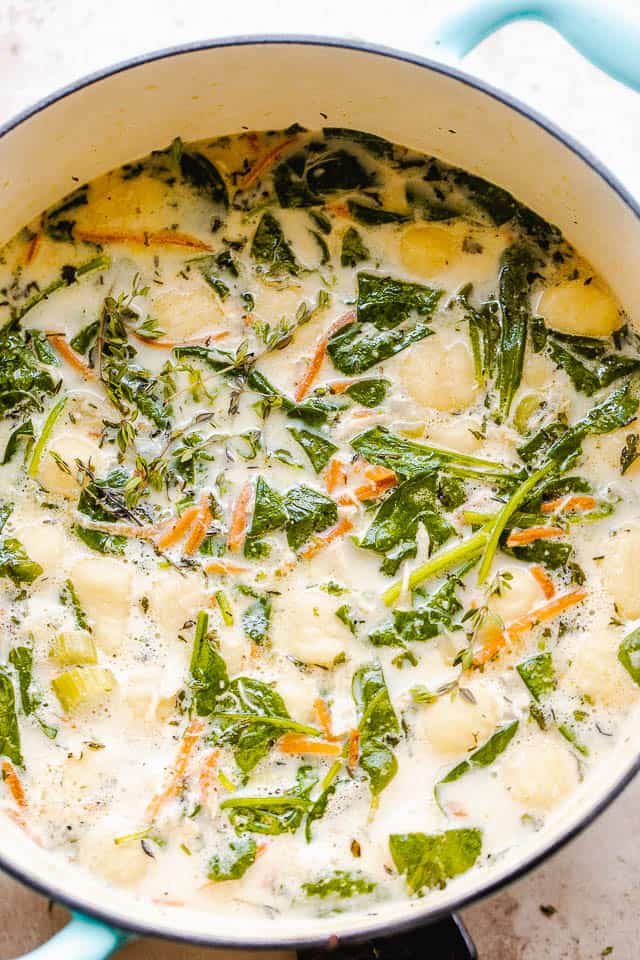 creamy gnocchi soup with spinach and chicken pictured in dutch oven