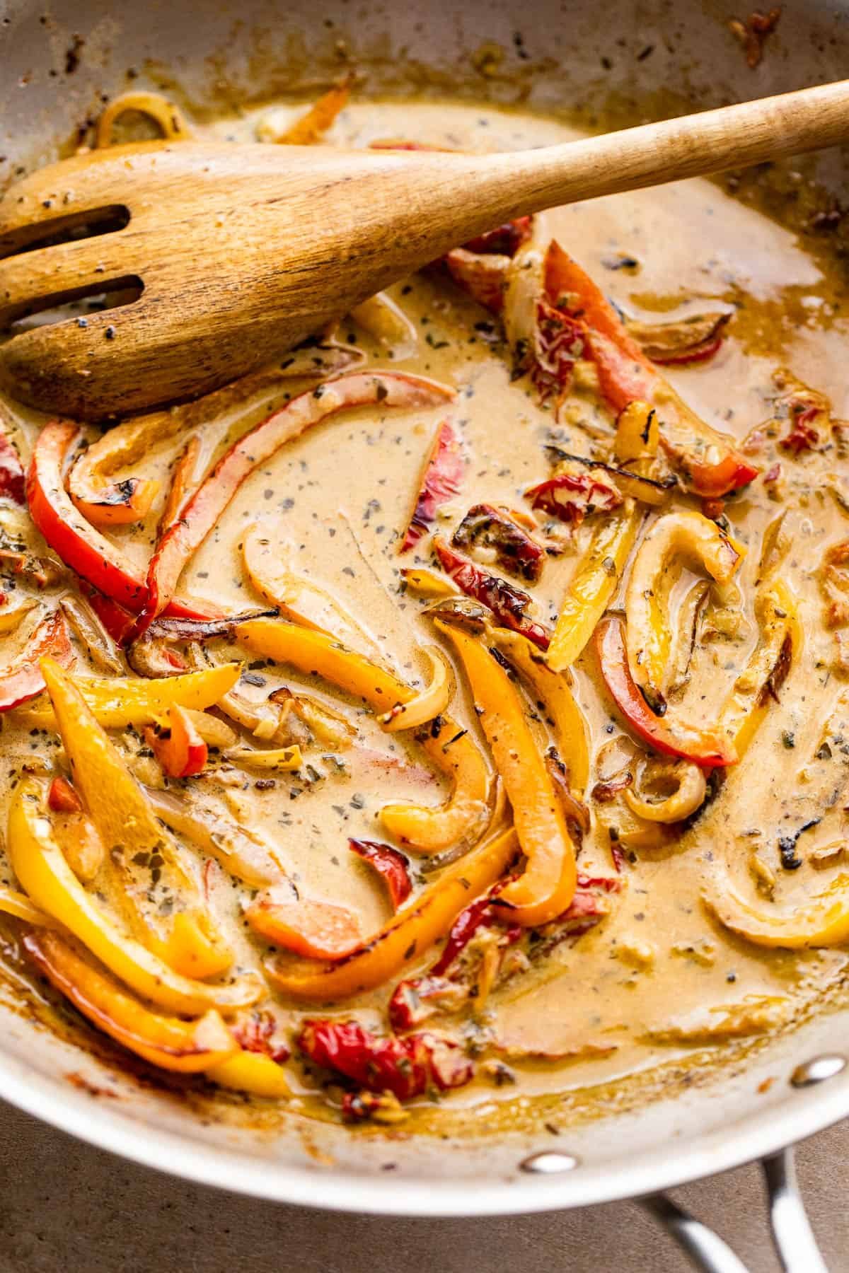 cooking bell peppers in a cream sauce with pesto