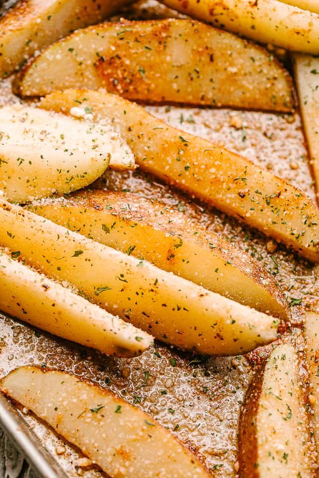 Close up of baked potato wedges.