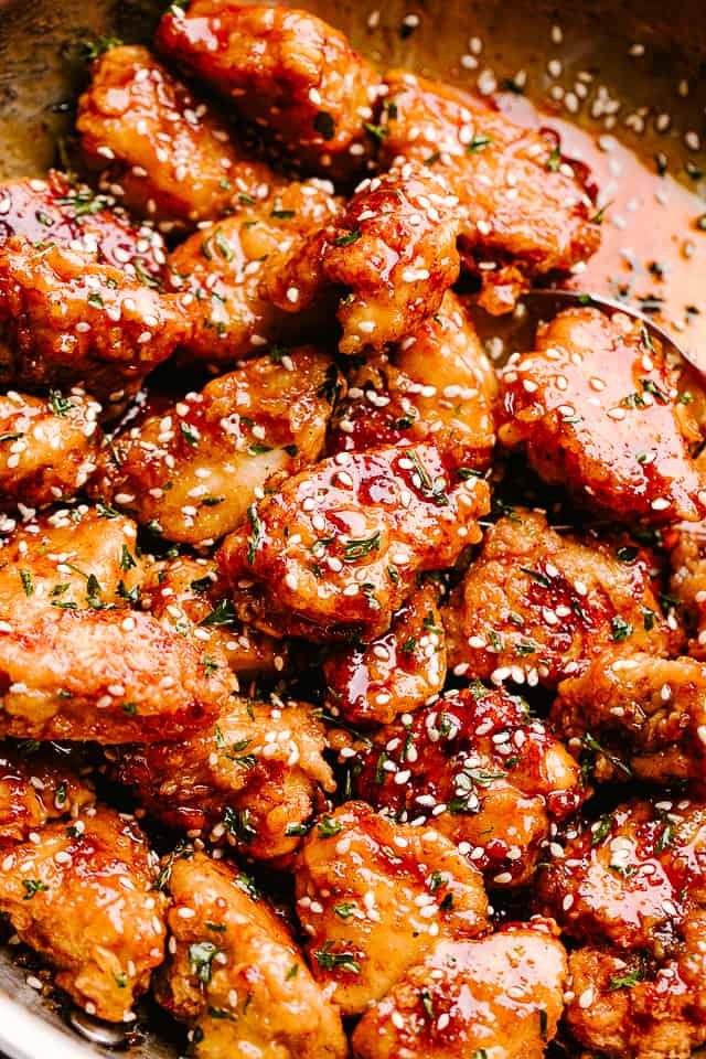 Crispy Honey Sesame Chicken garnished with sesame seeds and served on a plate
