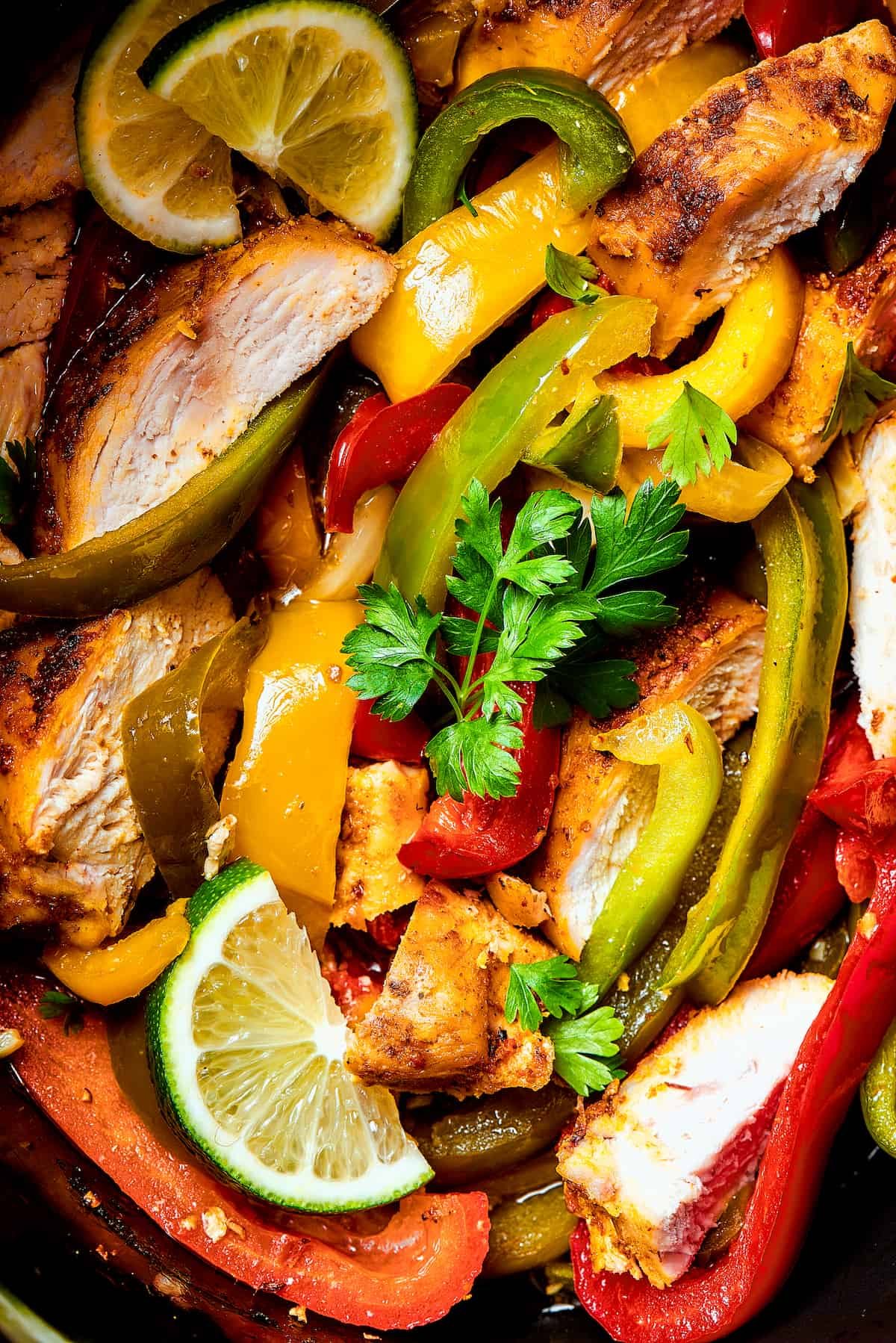 Close-up shot of seasoned chicken and veggies in a slow cooker.