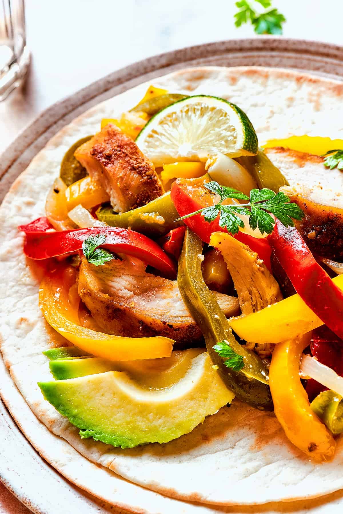 Close-up shot of tortillas with fajita chicken.