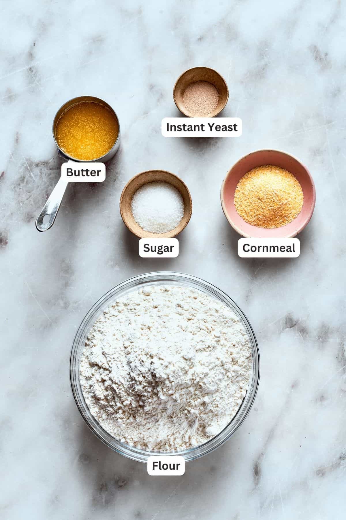 Deep dish pizza crust ingredients: flour, cornmeal, butter, sugar, instant yeast.