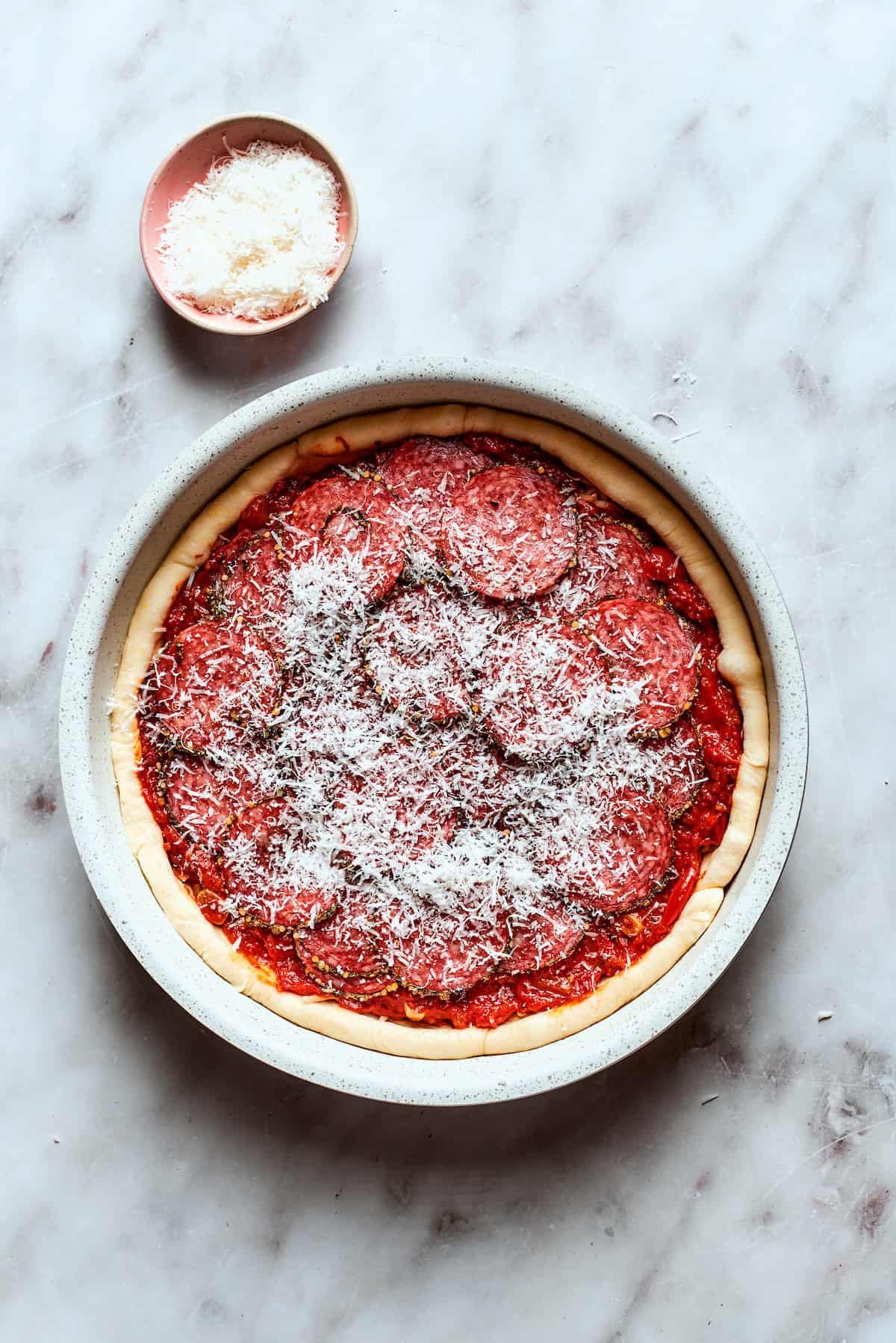 Parmesan cheese is scattered over the top of the pizza.