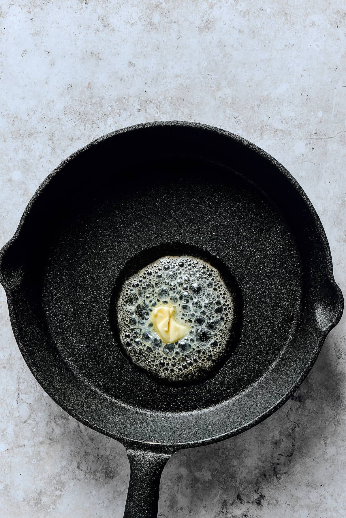 Melting butter in a skillet.