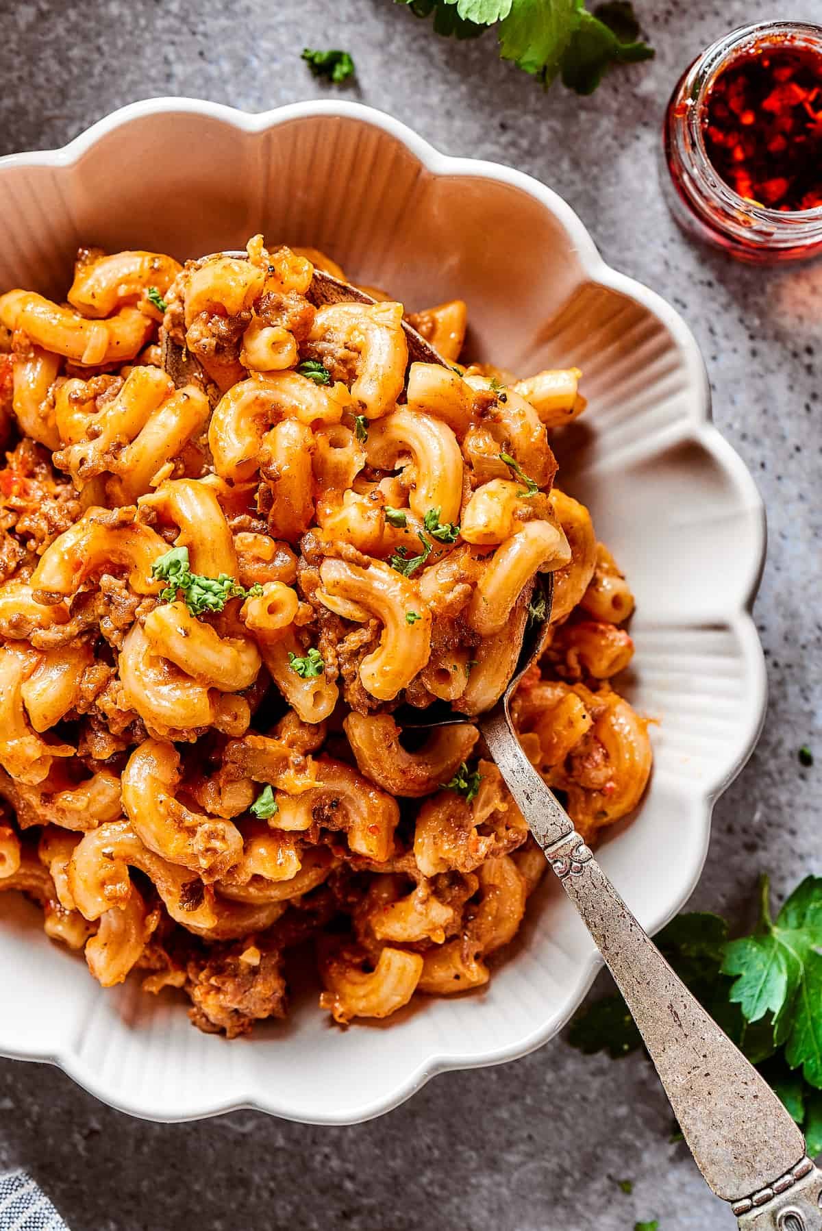 A bowl of pasta casserole with beef.