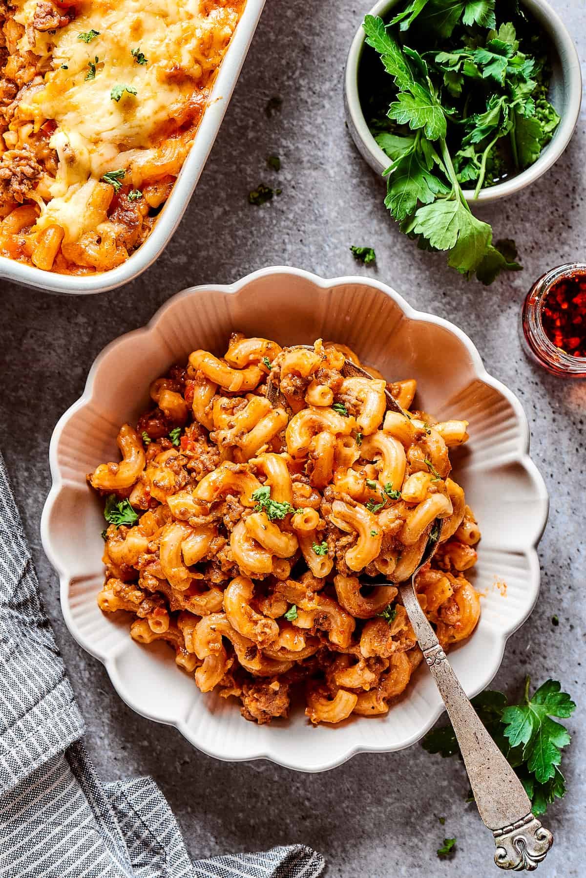 Cheeseburger casserole in a bowl with fluted edges.