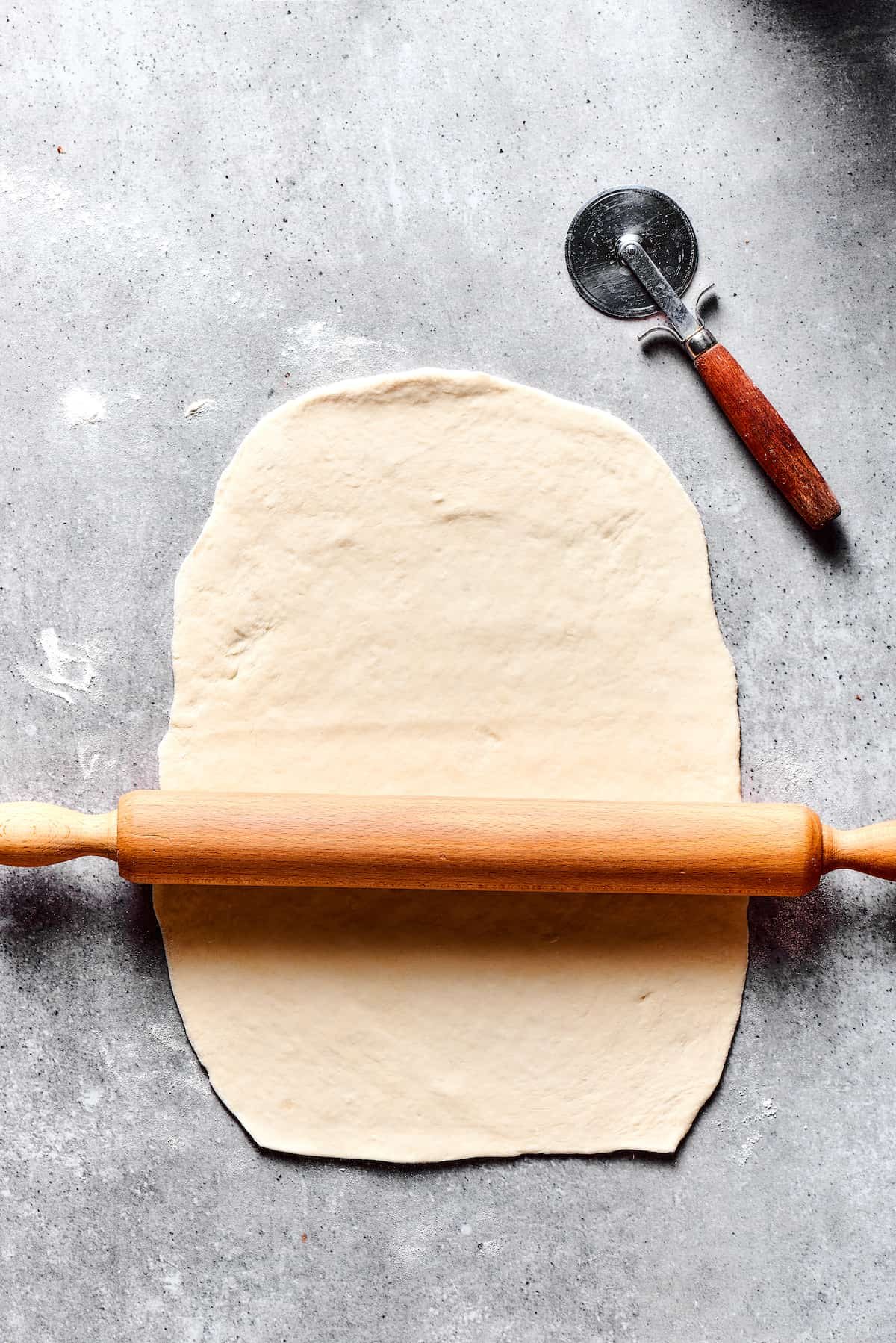 Rolling out dough on a work surface.
