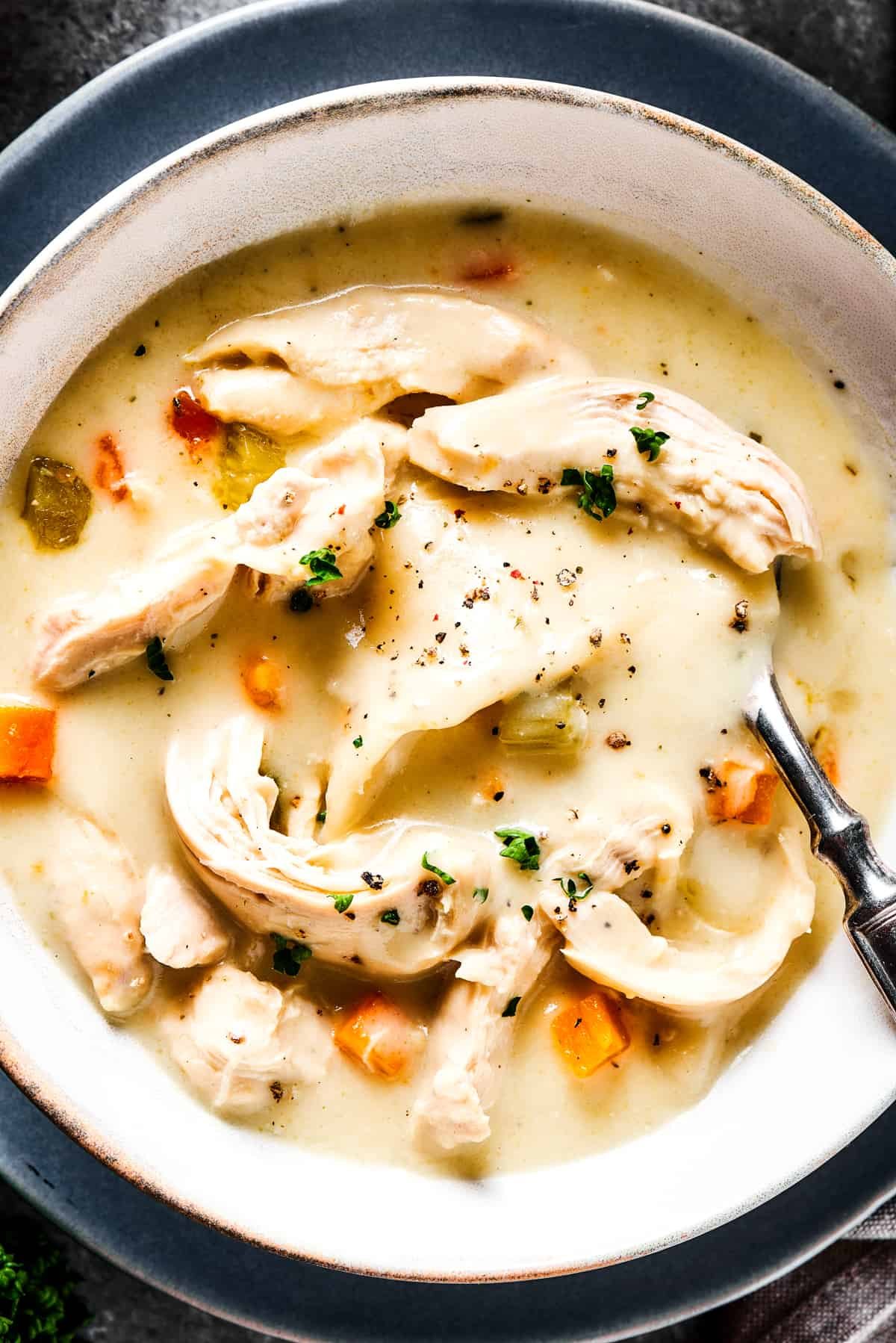 Thick chicken soup garnished with herbs.