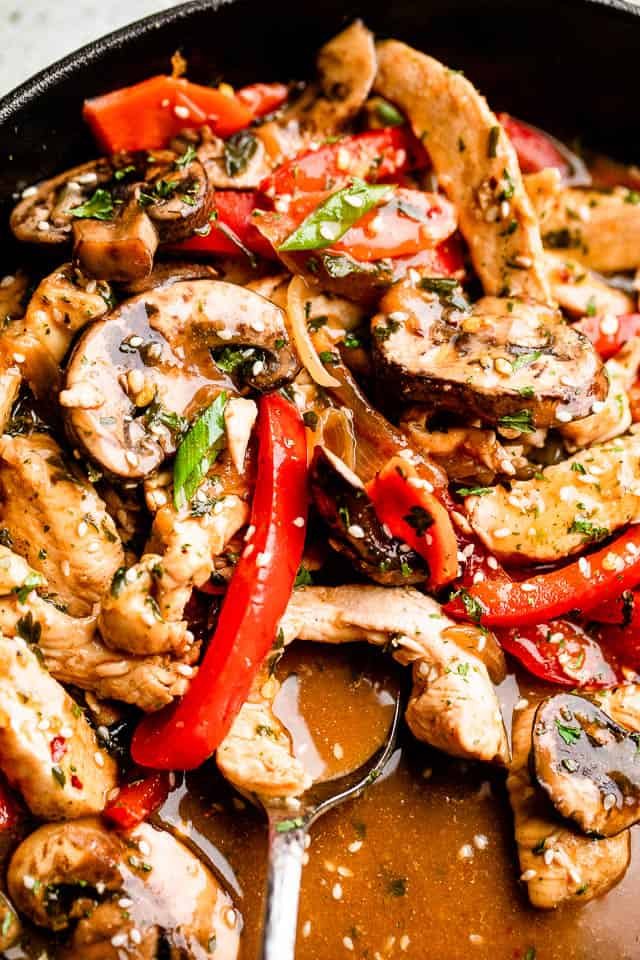 cooked chicken, mushrooms, and peppers in a wok