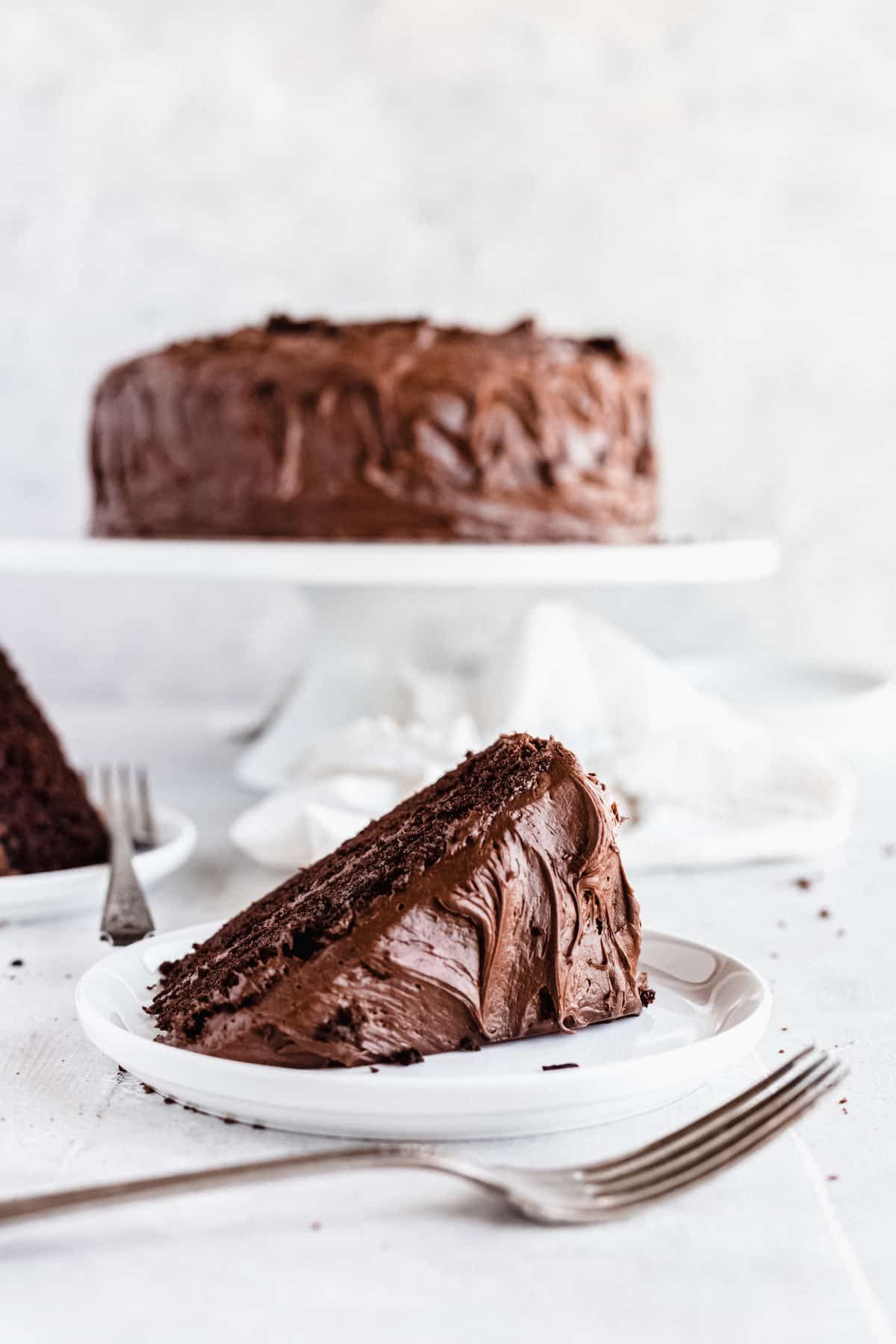 A Sideways-Lying Slice of Chocolate Cake on a Countertop with a Fork