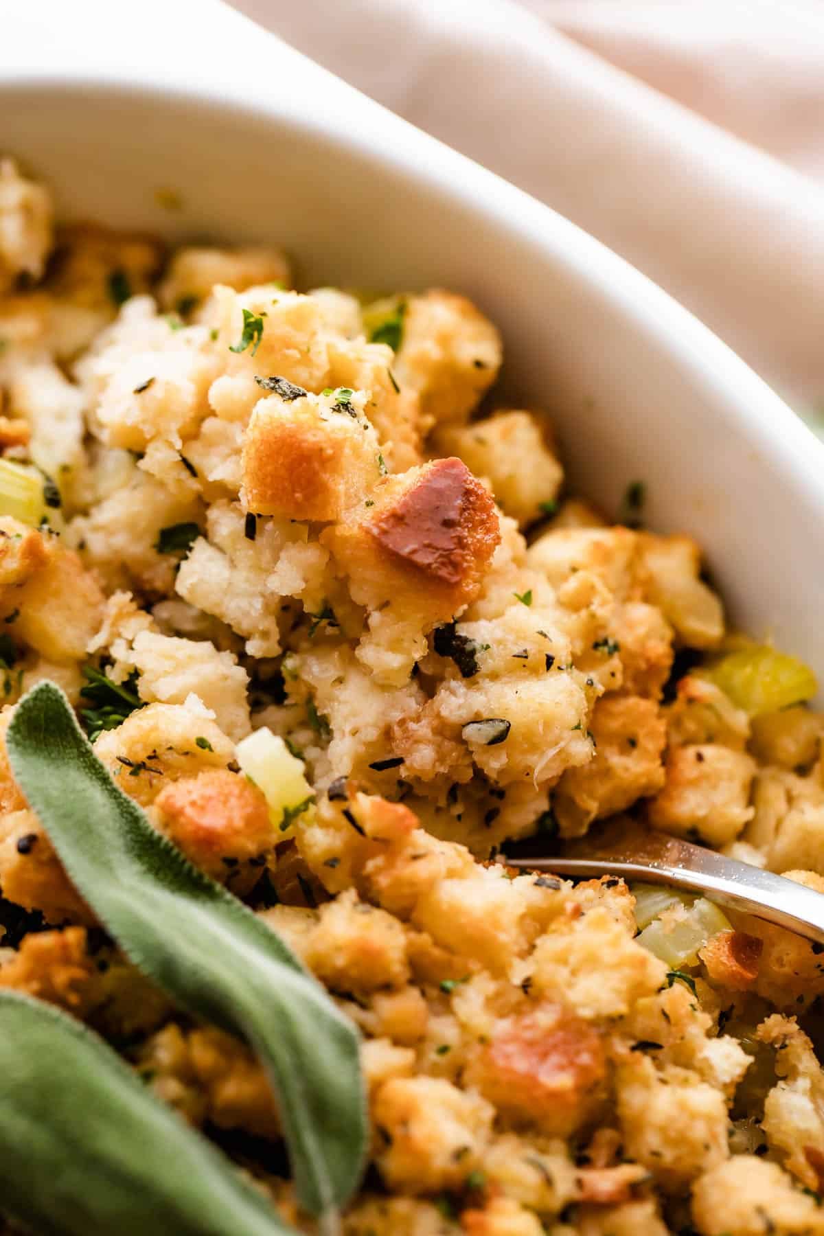 A close-up shot of herb stuffing, showing the texture of the bread cubes.
